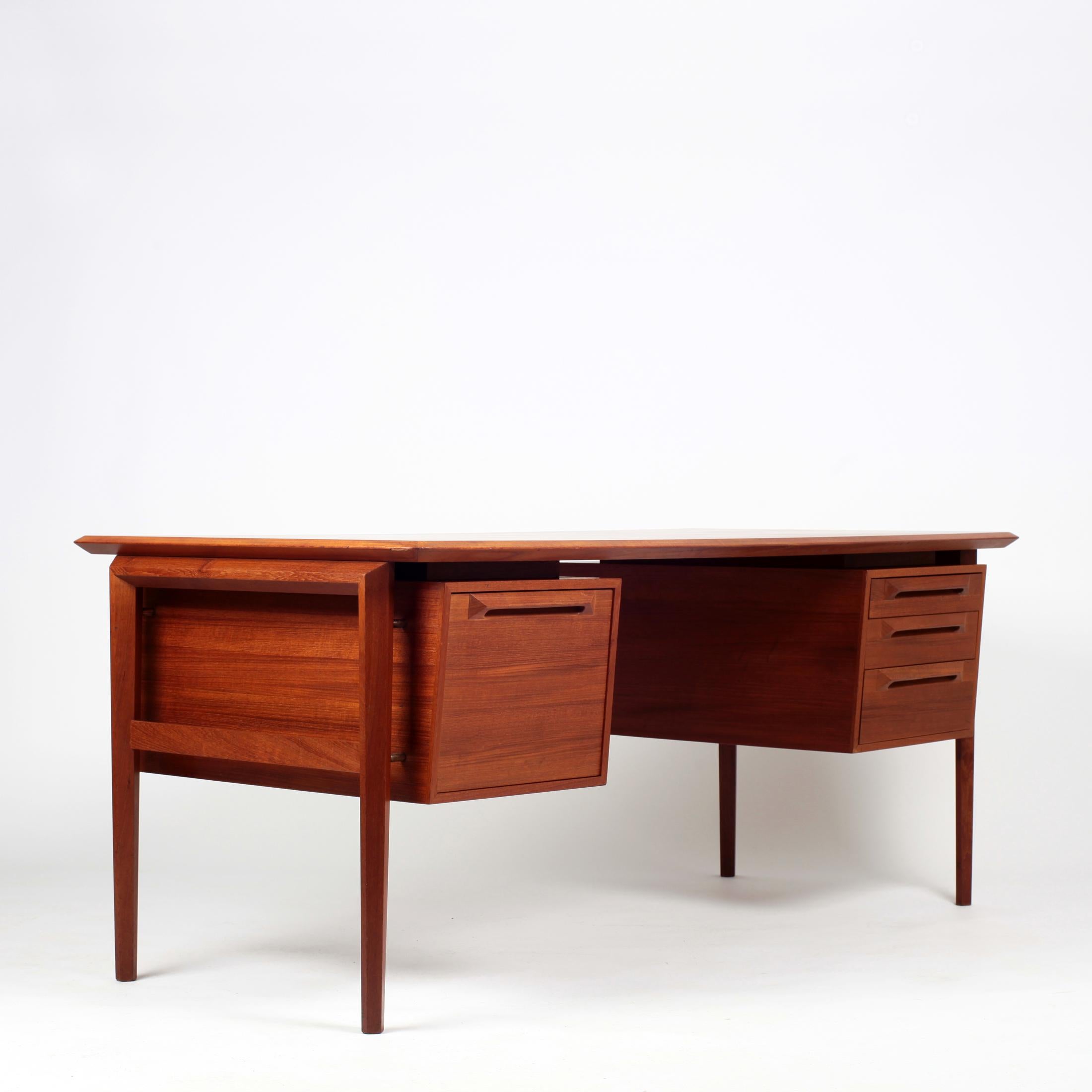 Large desk designed by Ib Kofod-Larsen (Denmark) for Seffle Møbelfabrik, Sweden, 1960s.
Teak with copper details.
Features three drawers on the right side and one file drawer on the left side
Original maker's stamp.
Very good condition, some