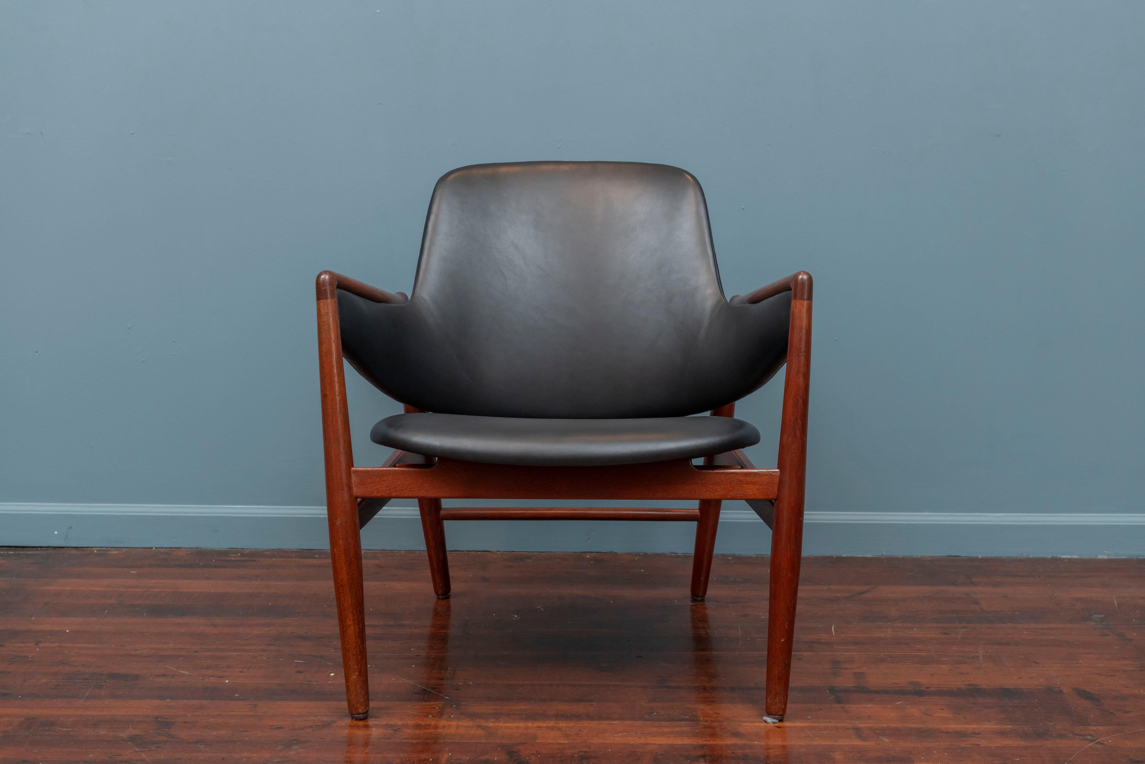 Rare Ib Kofod-Larsen design lounge chair for Christen & Larsen, Denmark. Very low production chair model, fully documented in 40 years of Danish furniture design catalog.
 Newly waxed teak frame and upholstered in new black leather, very comfy and