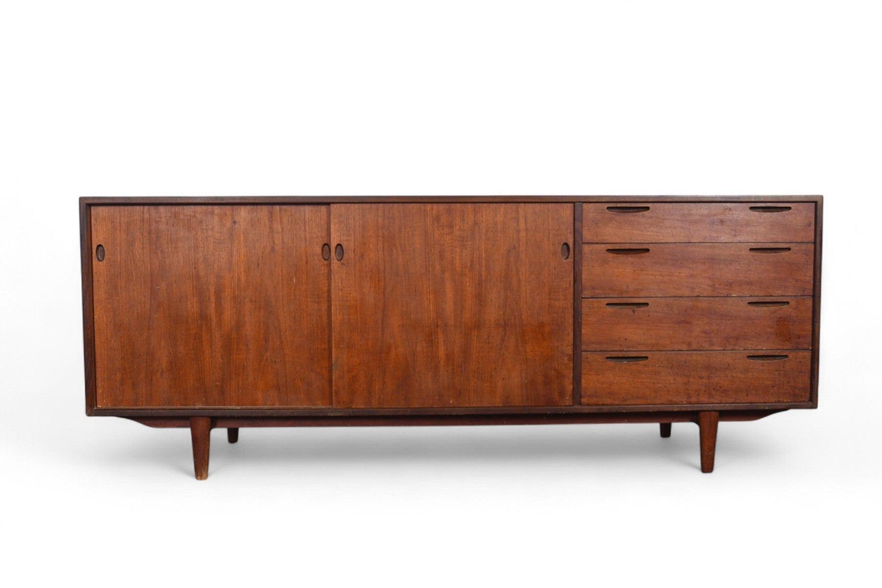 Origin: Denmark
Designer: Ib Kofod Larsen
Manufacturer: Brande Møbelindustri
Era: 1958
Materials: Teak, Afromosia
Measurements: 78.75″ wide x 17.75″ deep x 30.5″ tall