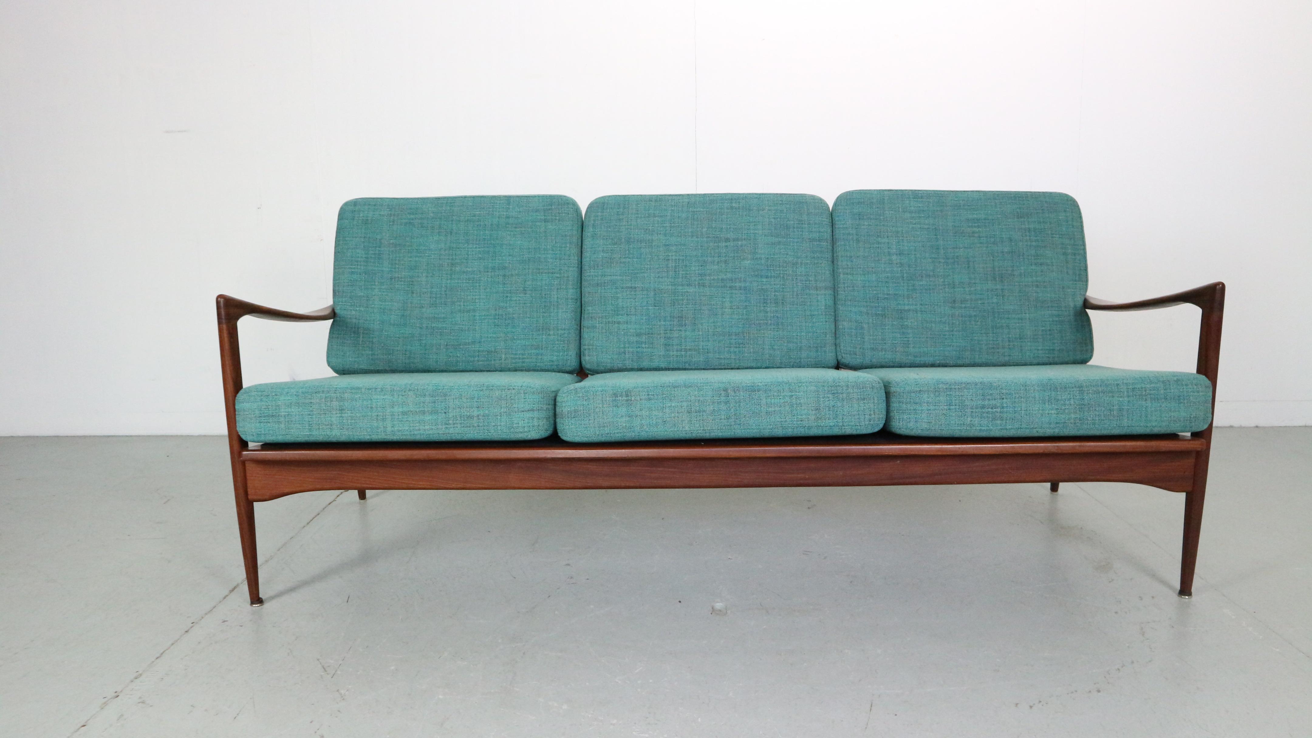 Stunning vintage three-seater sofa designed by Danish designer Ib Kofod-Larsen for Ope, Sweden. This model Kandidaten sofa features a stylish 1950’s design, teak afrormosia frame and comfortable seating. To ensure many more years of comfort we’ve