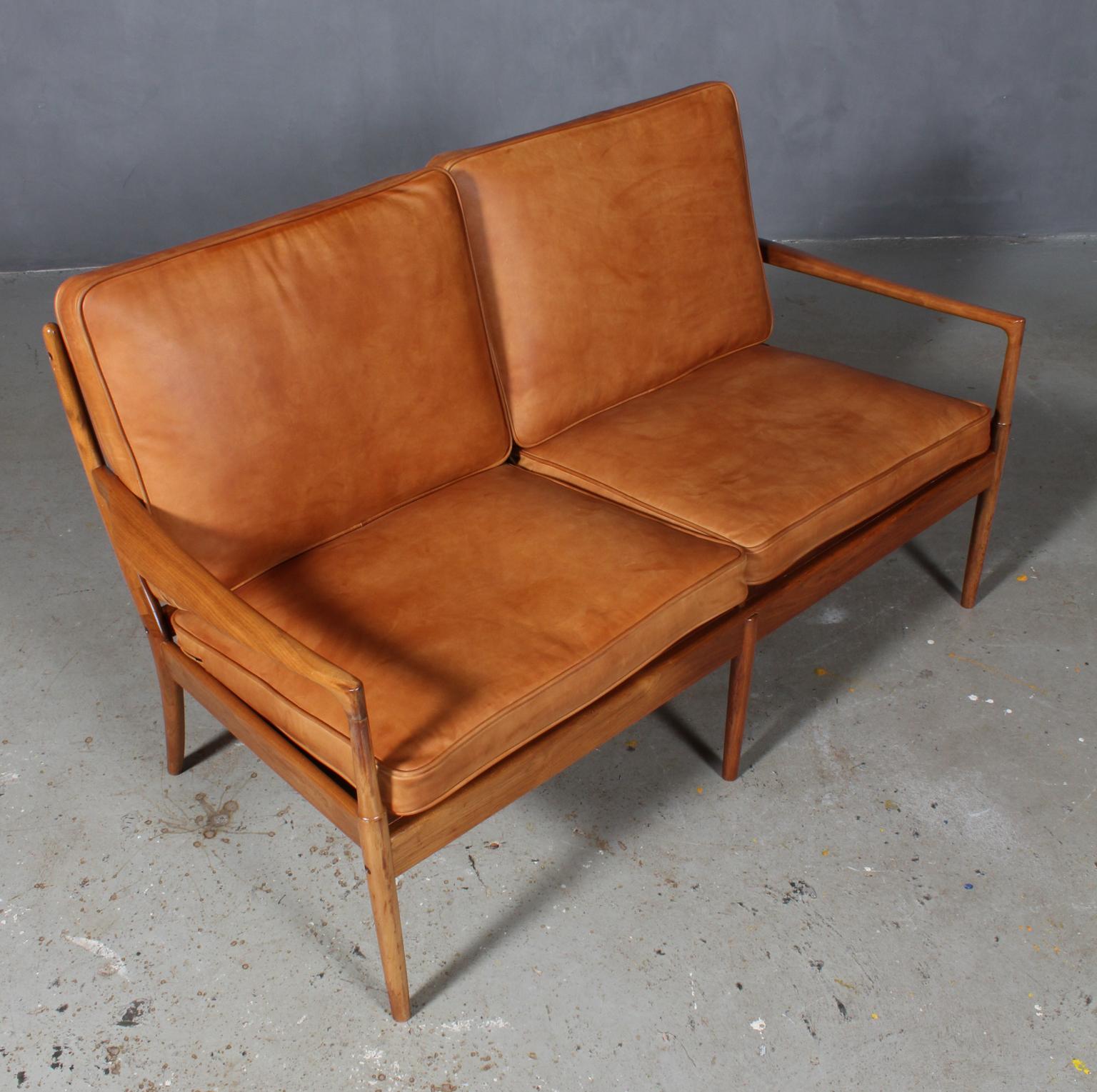 Ib Kofod-Larsen two-seat sofa with frame of walnut.

New upholstered cushions in vintage tan aniline leather with tubings.

Model Samsö, made by Ope.

Rarely seen as a sofa.