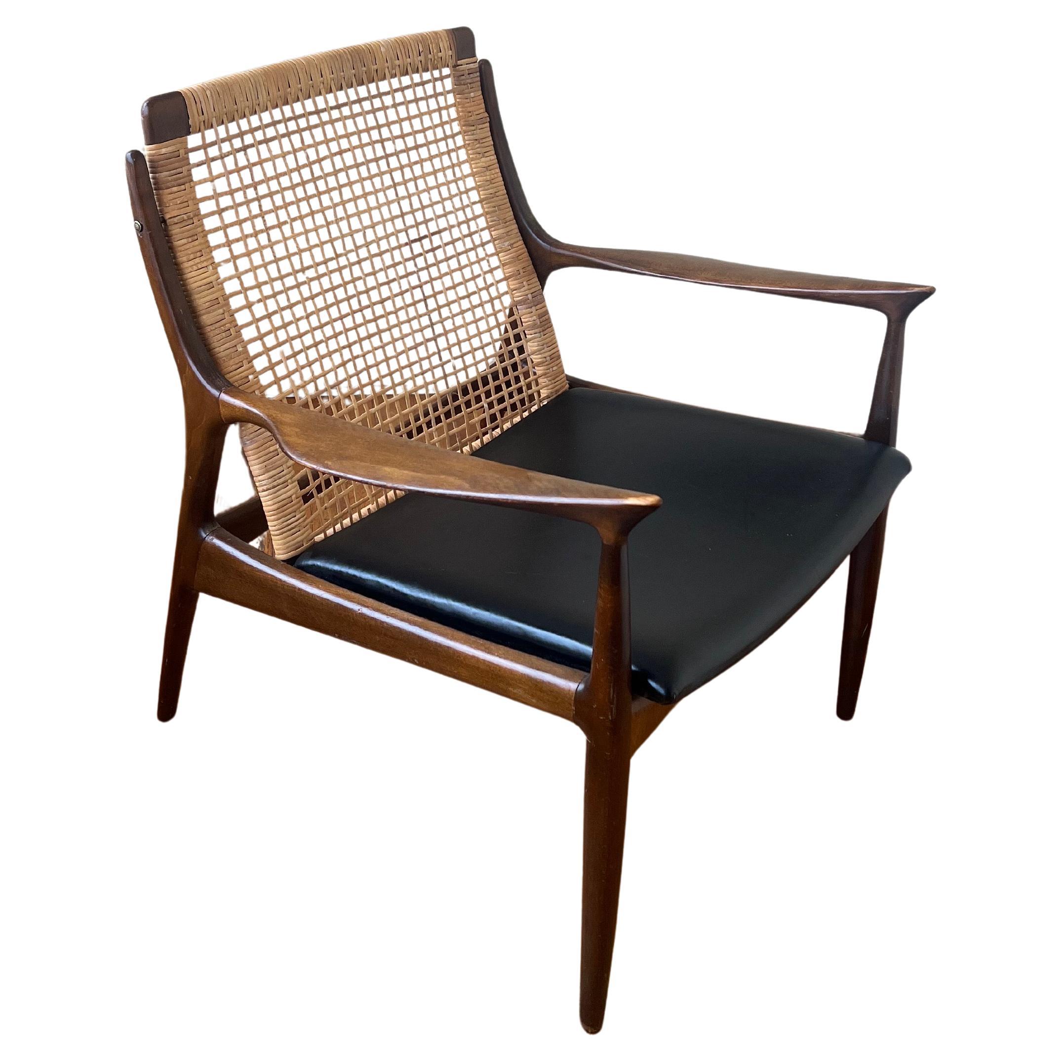 Classic Danish lounge chair by IB Kofod Larsen. A simply beautiful chair with great lines and a stunning profile. Chair is all orginal finish and seat original patina. Walnut frame is all original and in good, solid condition. Chair shows minimal