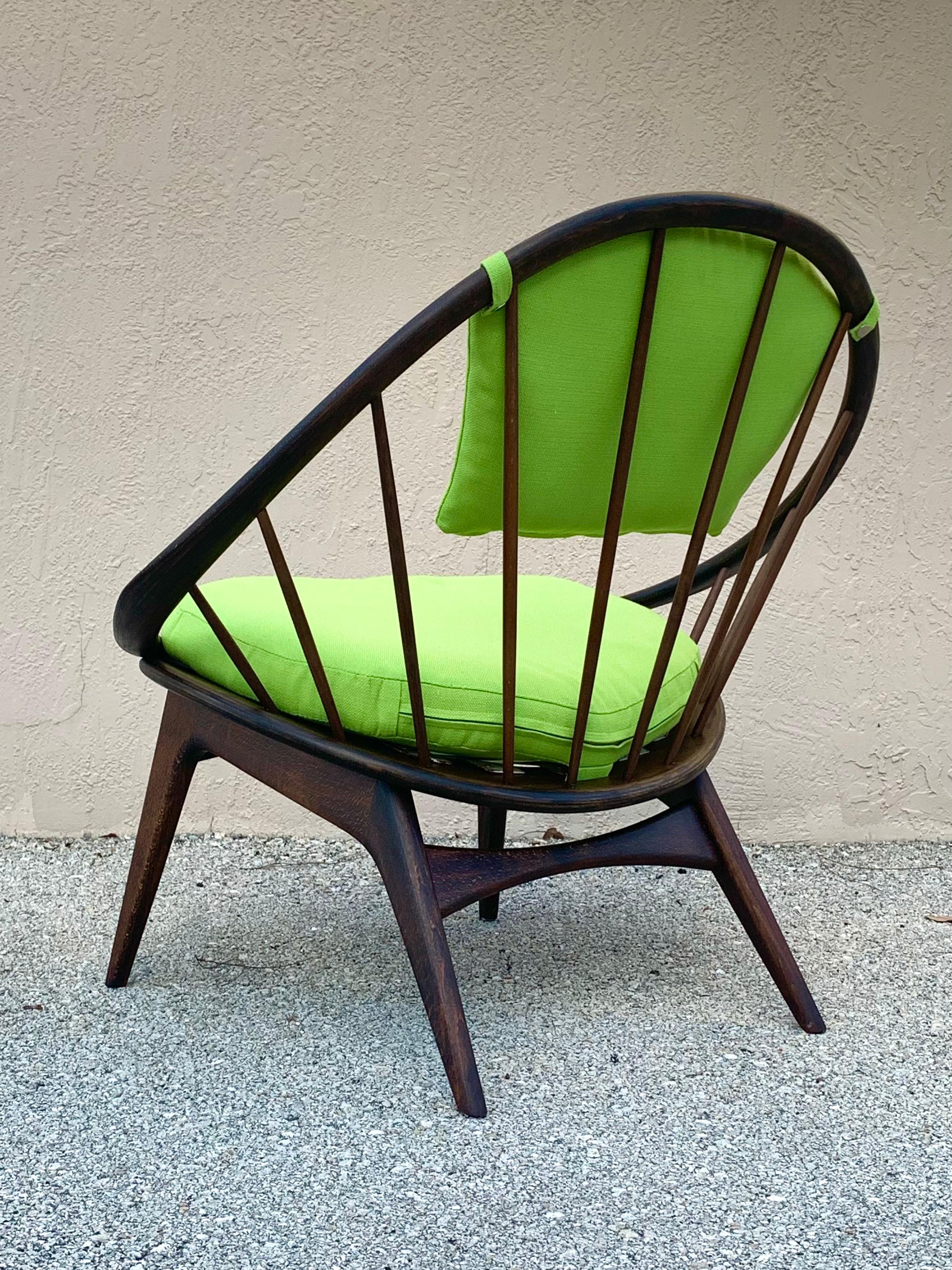 IB Kofod Larsen hoop chair. A hoop of plied walnut supported by a gorgeous display of spindles arranged in a peacock pattern. Recently refinished and reupholstered in a Bright green fabric. Made in Denmark. Would fit well in Mid-Century Modern,