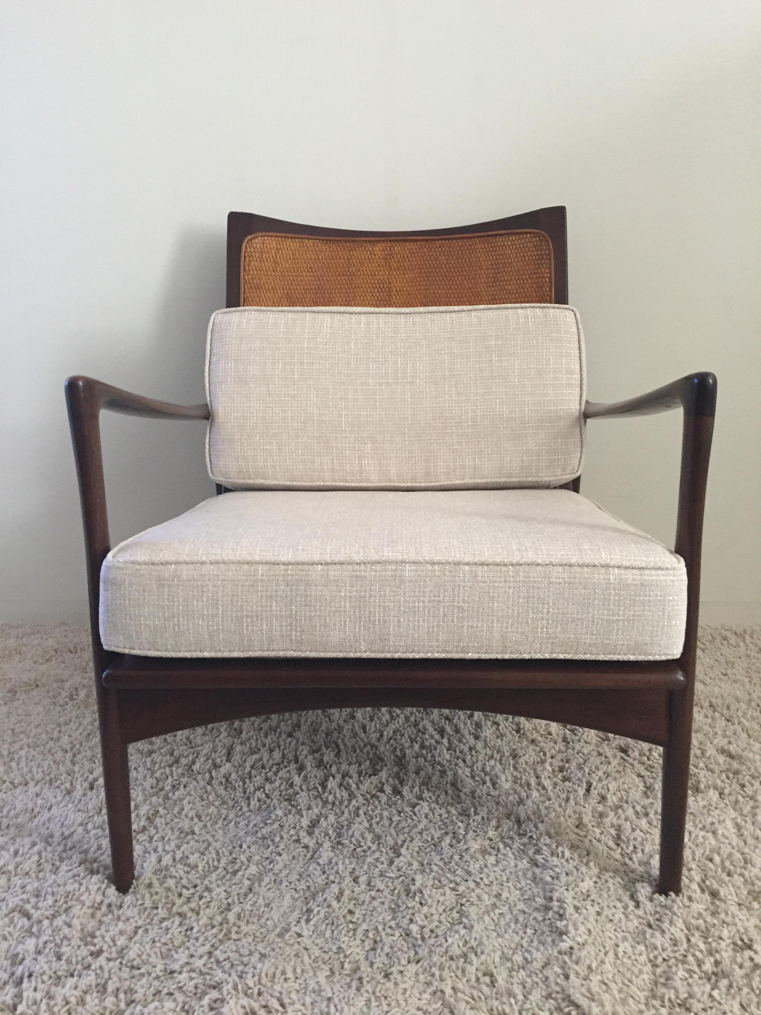 Ib Koford Larson cane back chair, caning in very good condition and finish, woven fabric chenille in wheat and cream color, rubber straps for comfort stamped, Denmark Selig Co. Design sleek.