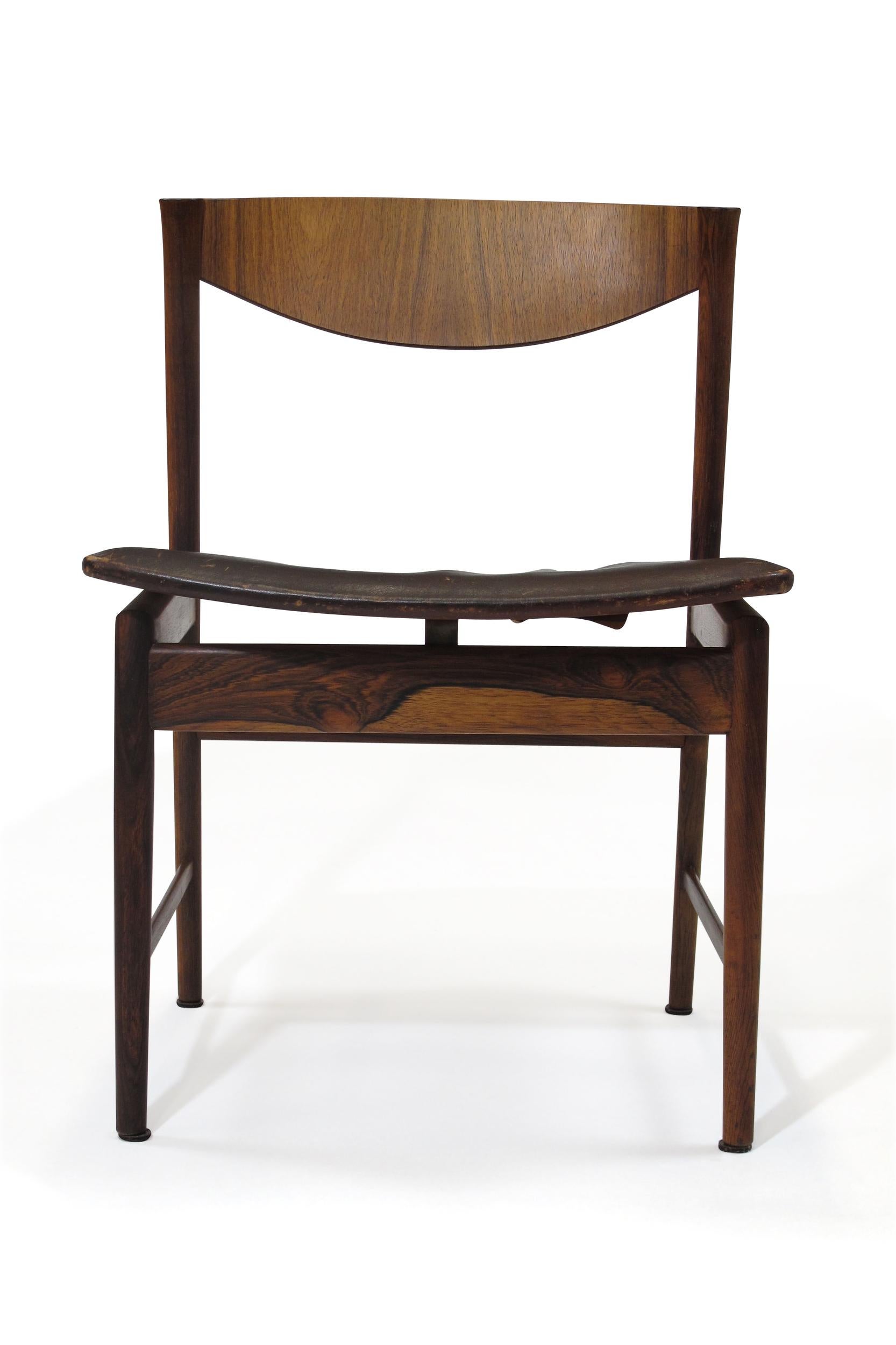 Rare set of eight solid Brazilian rosewood dining chairs designed by I.B Kofoed Larsen for Saffle Mobelfabrik Sweden. Features solid Brazilian Rosewood frames with rich grain and exquisite joinery. The floating seats are raised on an elegant frame