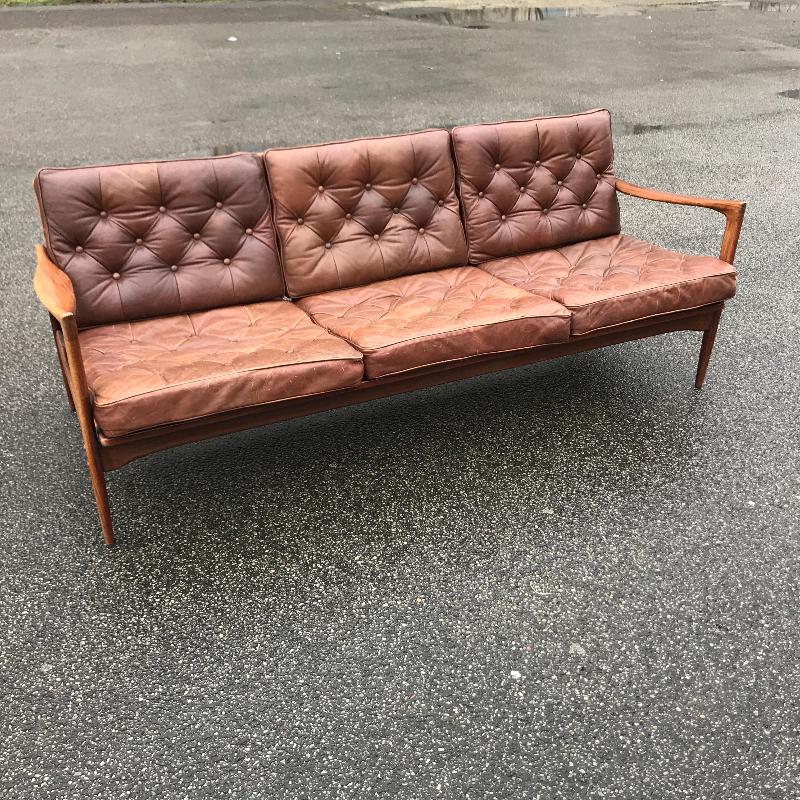 A stunning Mid-Century Modern vintage sofa from Ib Kofoed Larsen. The model `Kandidaten` stands out as a perfect piece of vintage Danish Design history.