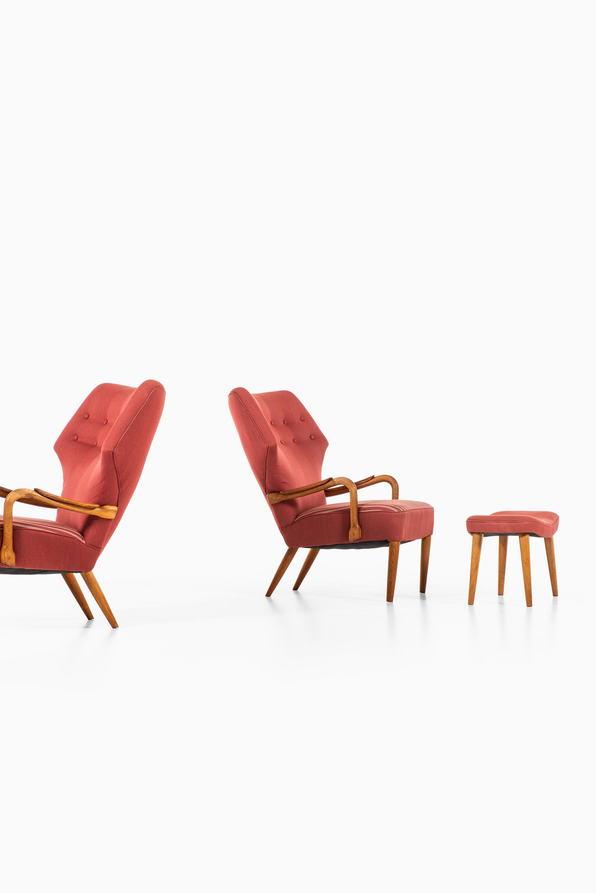 Rare pair of wingback easy chairs and stool attributed to Ib Madsen & Acton Schubell. Produced by E. & Sv. Olsen in Denmark.