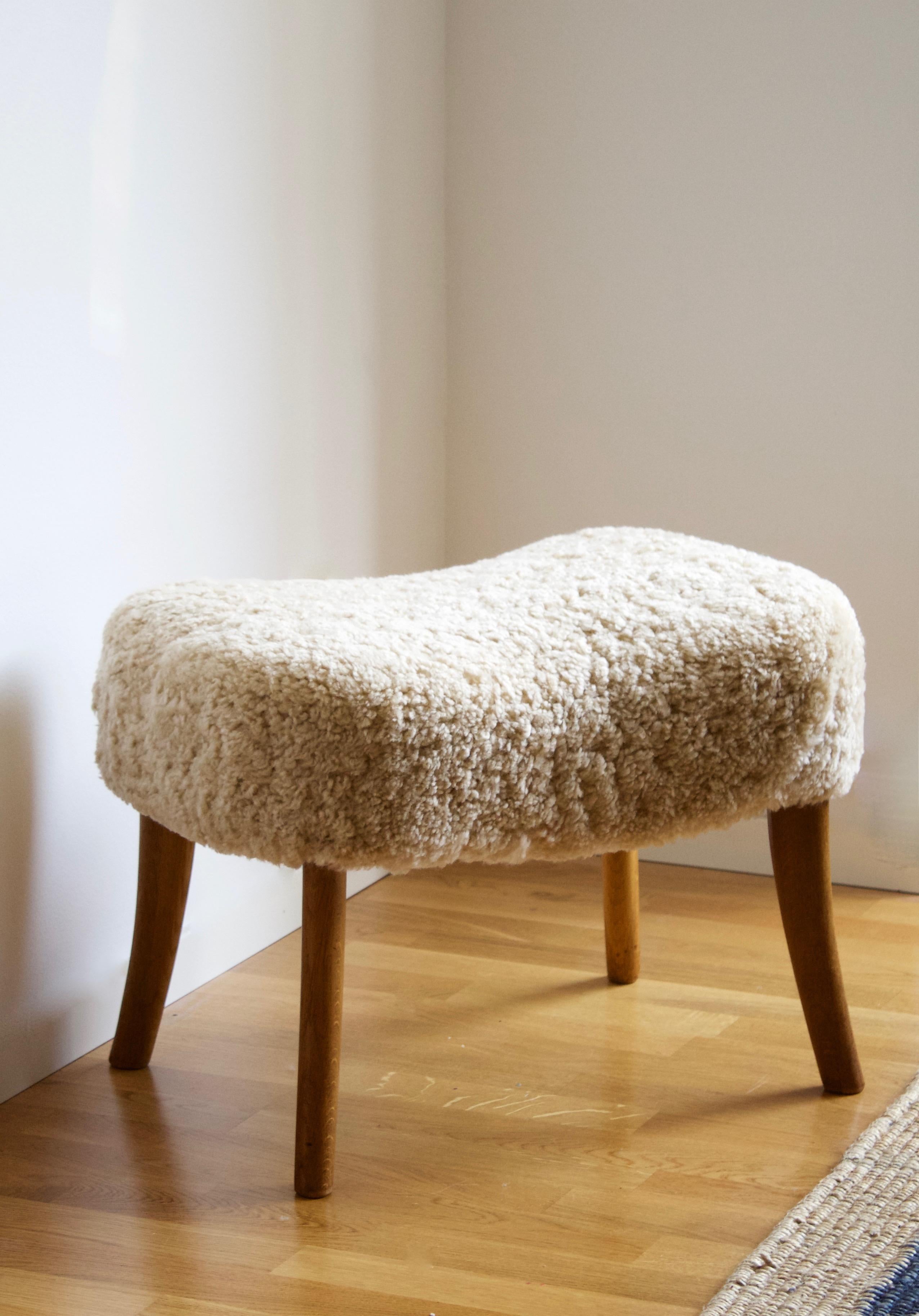 A stool. Designed and produced by Ib Madsen & Acton Schubell. Produced in Denmark, 1950s.

Reupholstered in brand new beige sheepskin.

Other designers of the period include Philip Arctander, Viggo Boesen, Gio Ponti, Vladimir Kagan, and Flemming