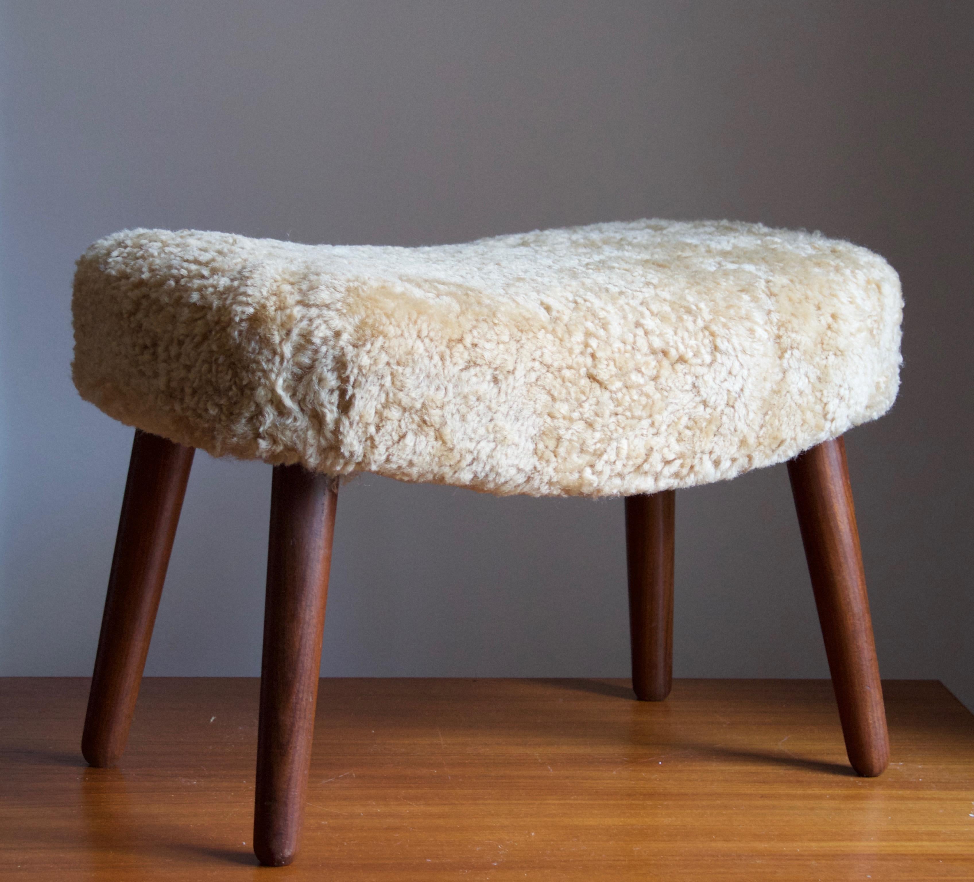 A stool. Designed and produced by Ib Madsen & Acton Schubell. Produced in Denmark, 1950s.

Reupholstered in brand new beige sheepskin.

Other designers of the period include Philip Arctander, Viggo Boesen, Gio Ponti, Vladimir Kagan, and Flemming