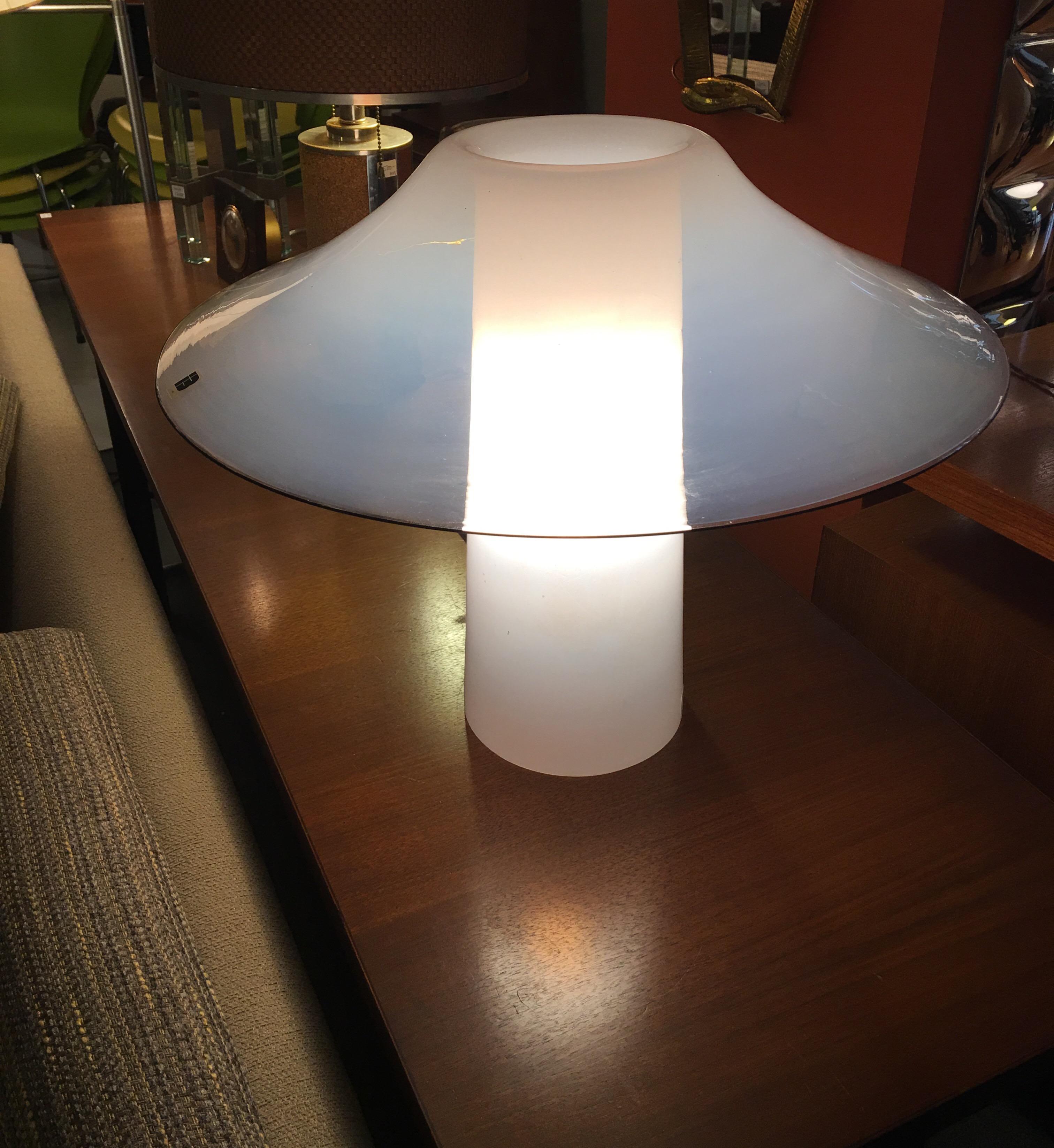 IB Tre Italian blown glass table lamp from the 1970s. All one piece with an interior mounted lamp socket. Lamp is translucent white with a black rim.