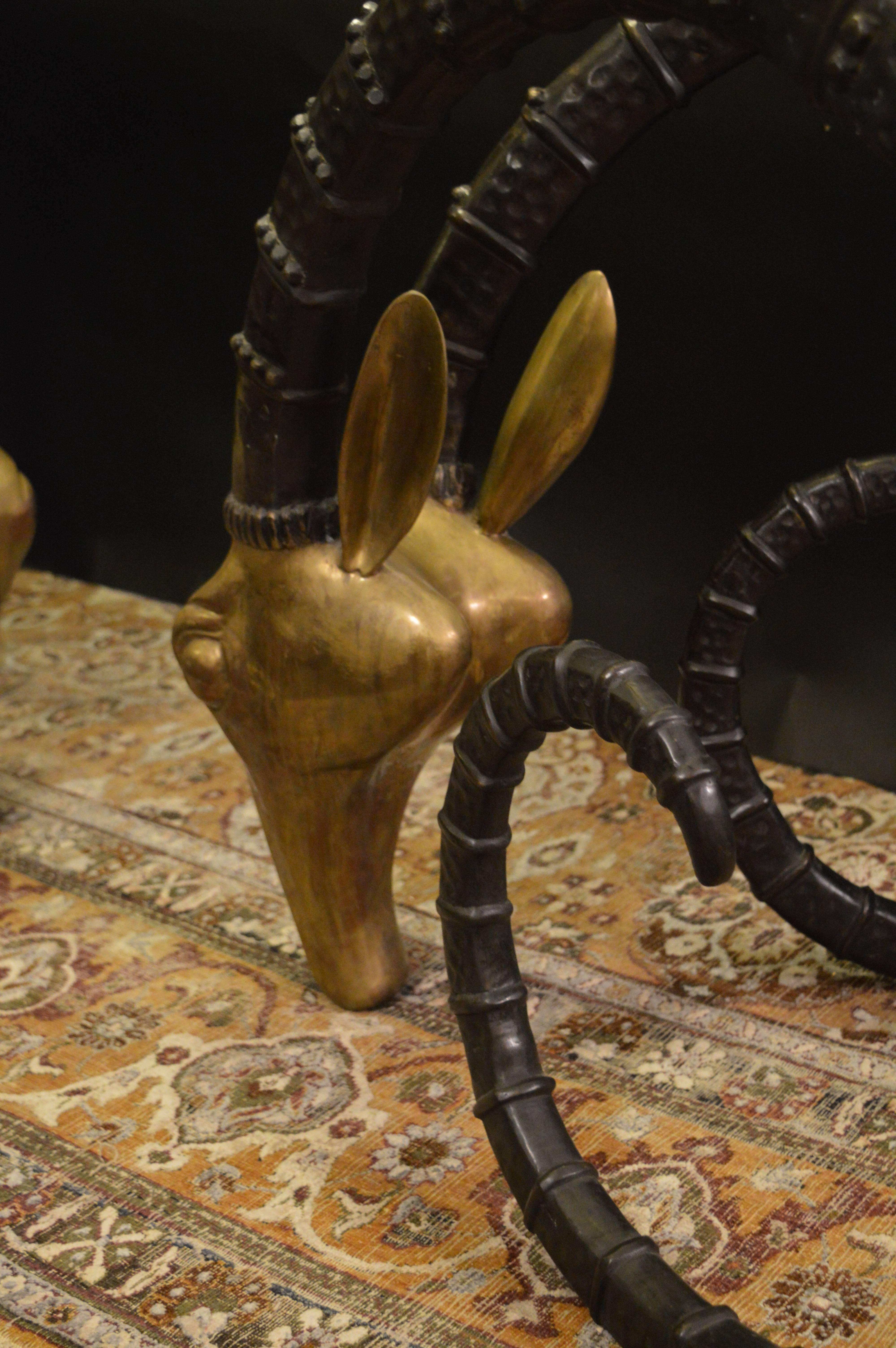 Dining table with two ibex heads in solid brass.
Measurements of the ibex head is 28.25