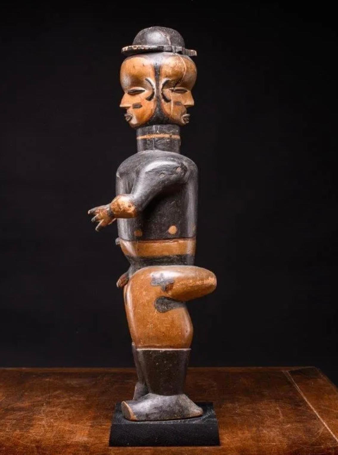 This elaborate Janus statue is a rare example of an Ibibio free-standing figure to recall a well-defined ancestor in what seems a European outfit .The Ibibios lend supernatural powers to these statues which are also used during divination
