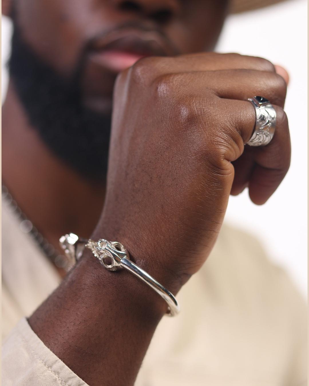 Ibibio (Leopard) Twin Skull Cuff
925 Sterling Silver
Handcrafted

Raymond Egbo, a New York born designer and creator of Afro-Inspired fine jewelry and accessories. This drive to cultivate a presence that unifies the world and Afro-Culture through