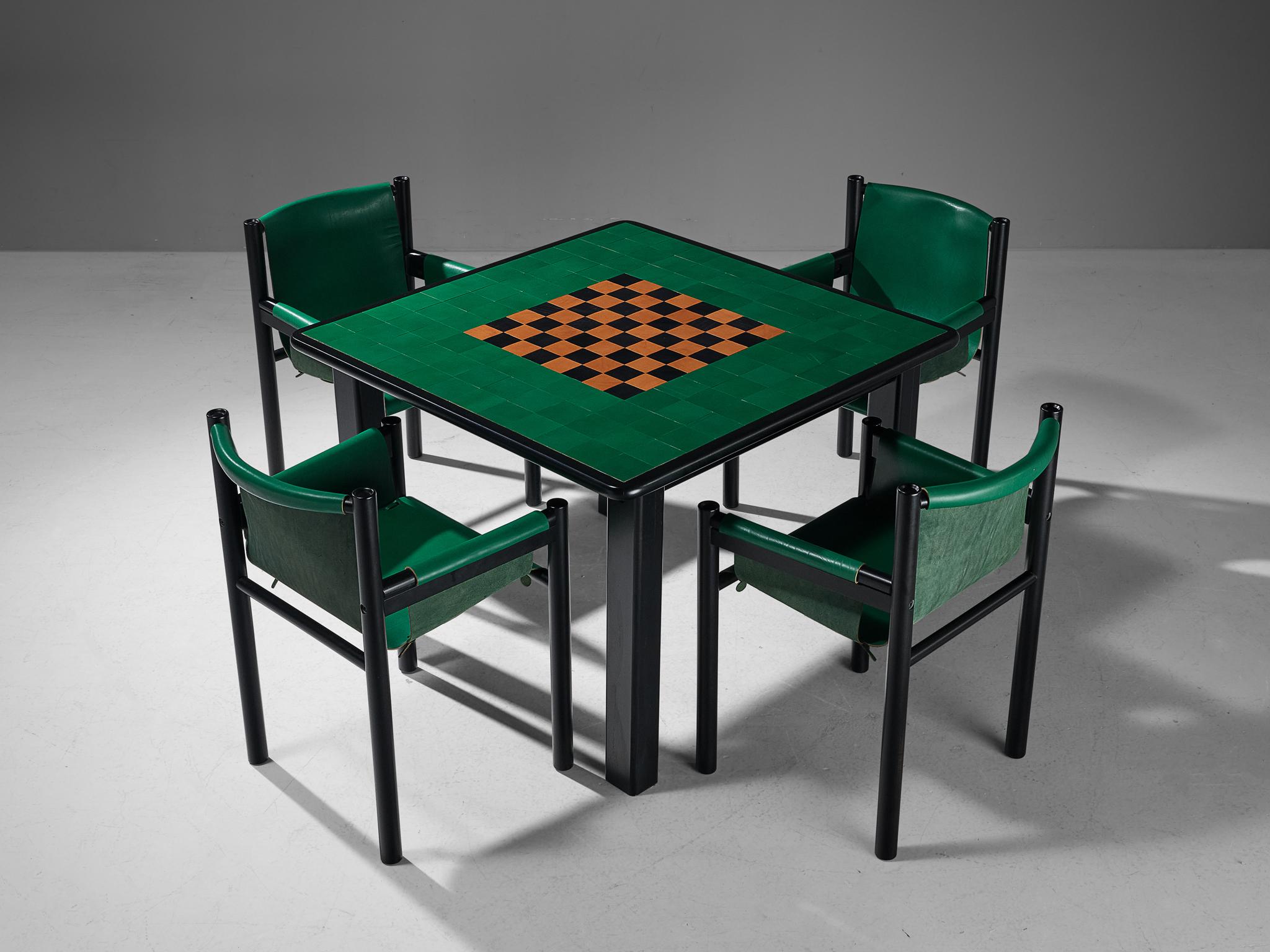Ibisco Sedie, set of game table and four armchairs, leather, lacquered wood, Italy, 1970s 

This design truly fits within the postmodern design ethos of the seventies. The tabletop displays a chequered pattern of black and cognac squares that is