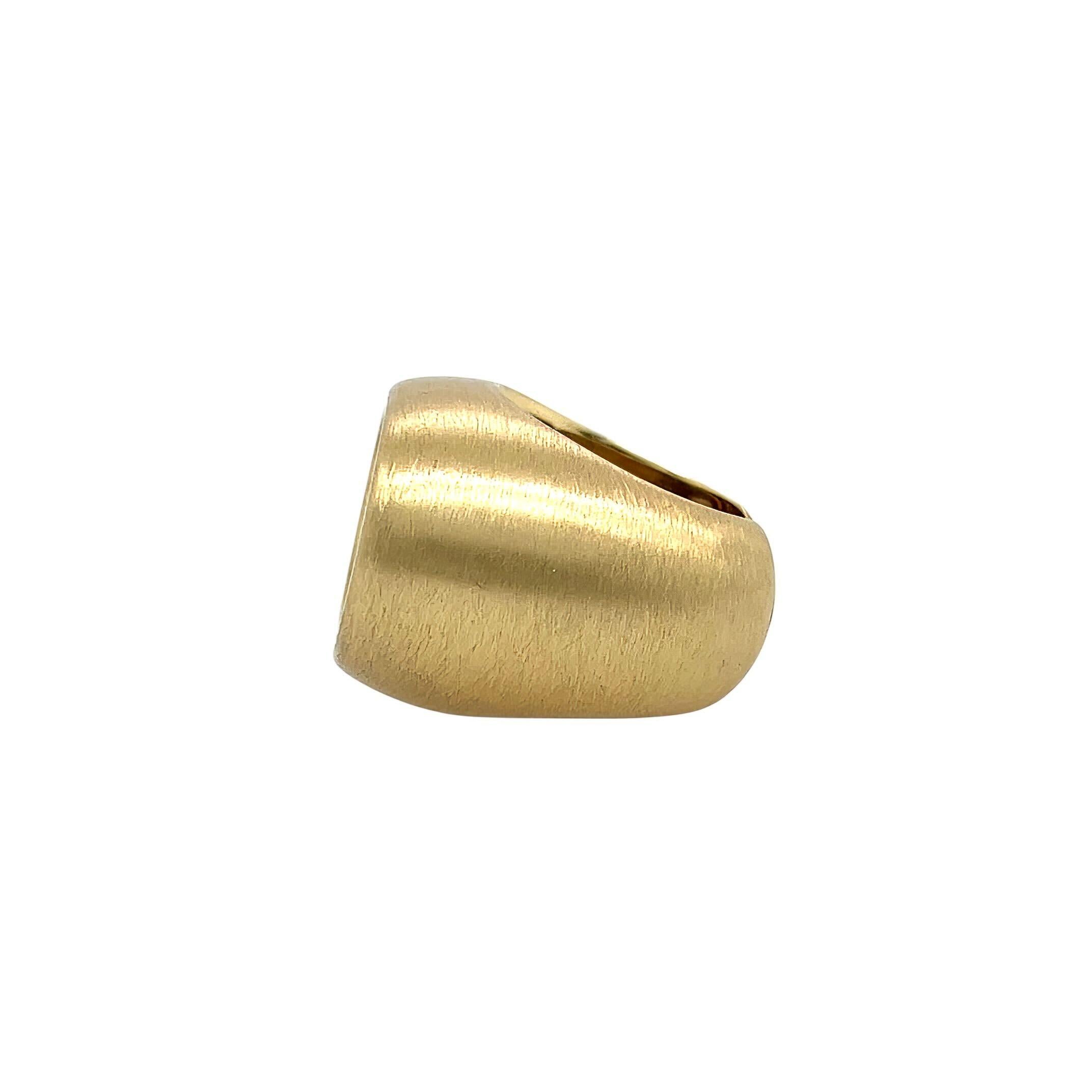 Un anello in oro giallo 18 carati e corniola, IBU.  Disegnato come un'ampia fascia affusolata al centro di un'incisione ovale in corniola con un'iscrizione araba che recita 