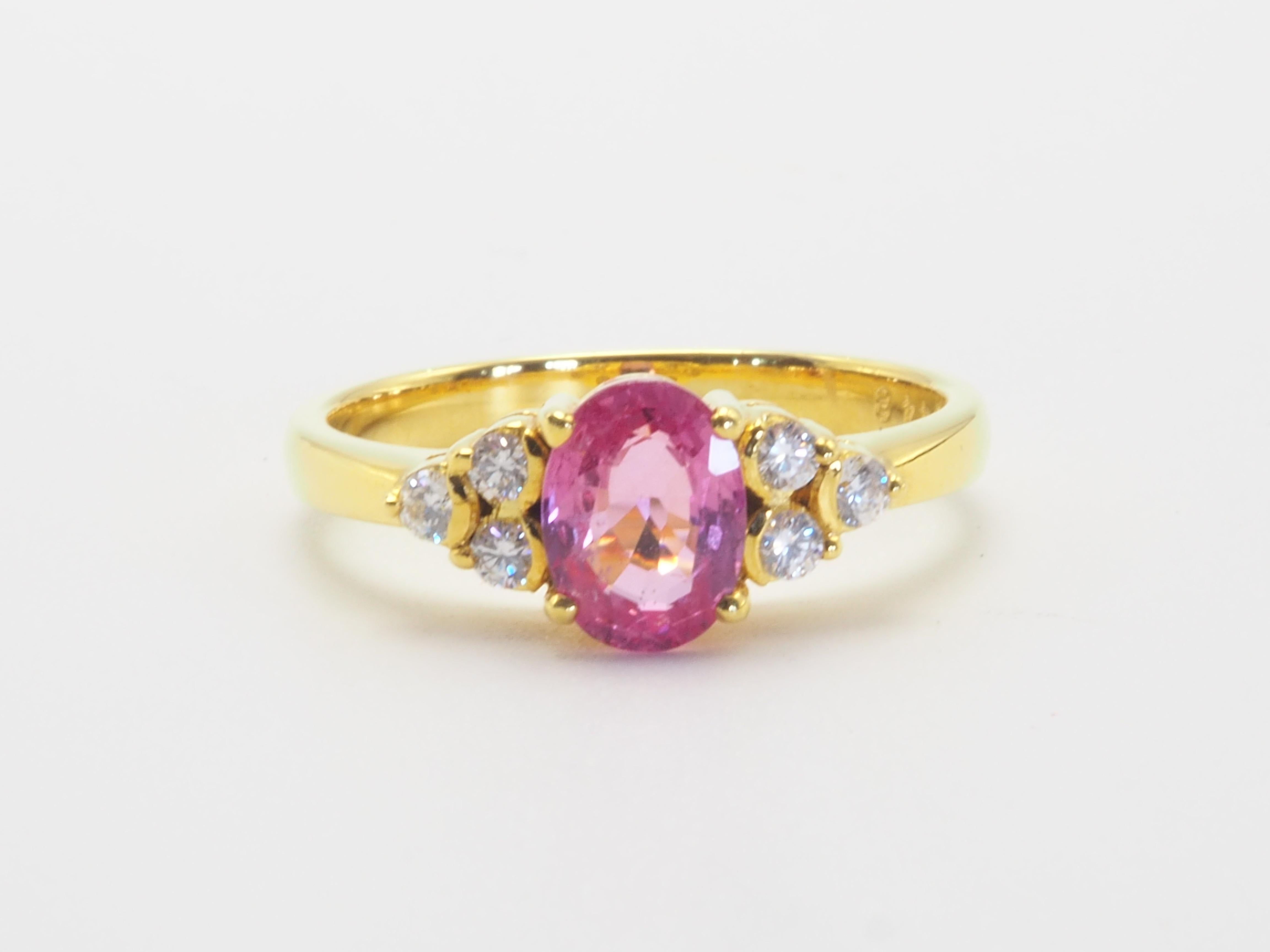 Fine classic and precious engagement ring in 18k solid yellow gold. The main gemstone is the rare and prized pink colored oval sapphire, almost flawless and highly saturated pink. The diamonds are 6 stones and is very clear, bright and lively which