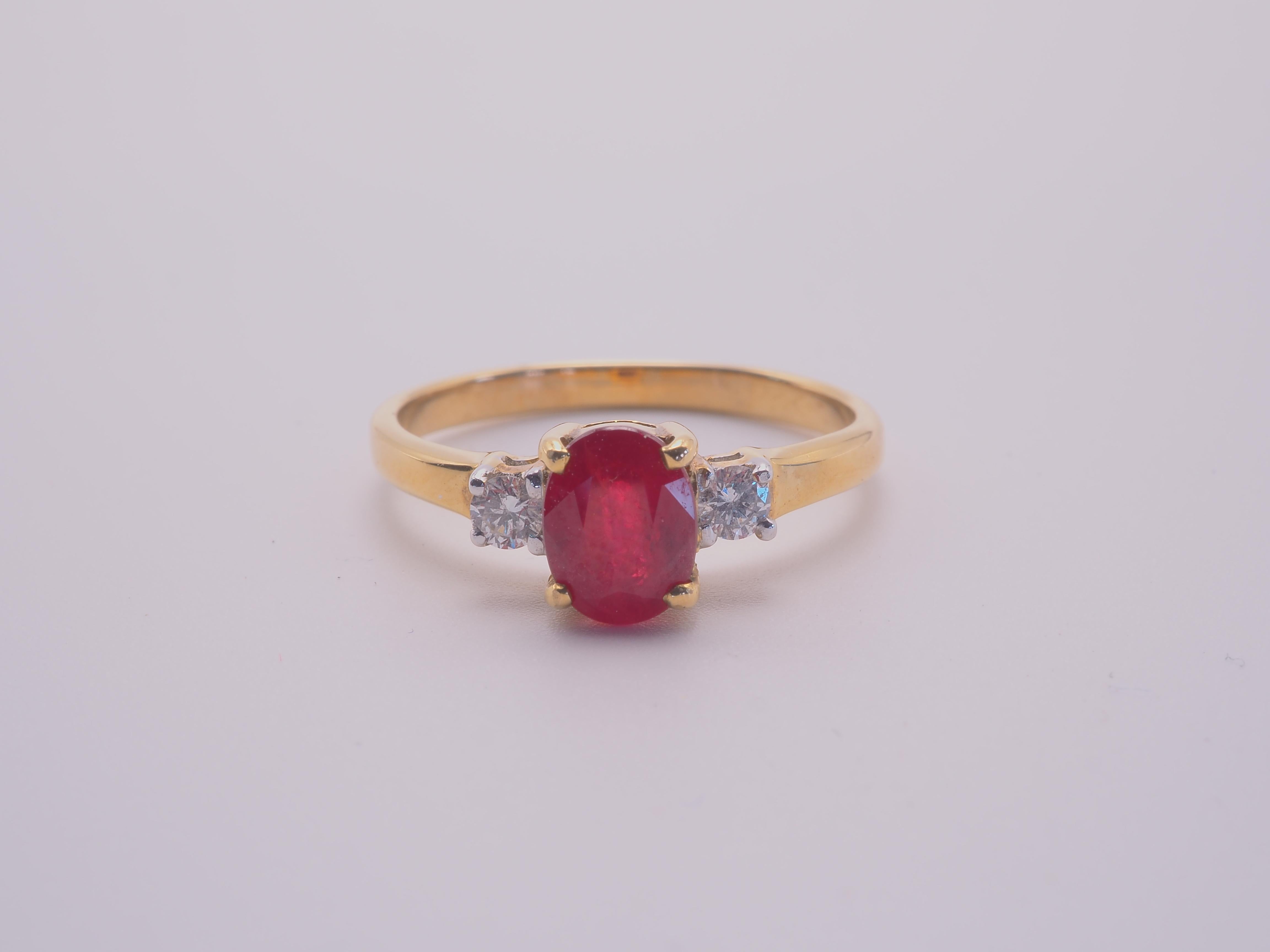 This amazing three-stone engagement ring boasts an oval cut ruby of 1.11 carats. The stunning oval cut ruby is set between 2 brilliant cut and decent size diamonds of good grade. Immaculate craftsmanship can be seen in all parts of the ring which is