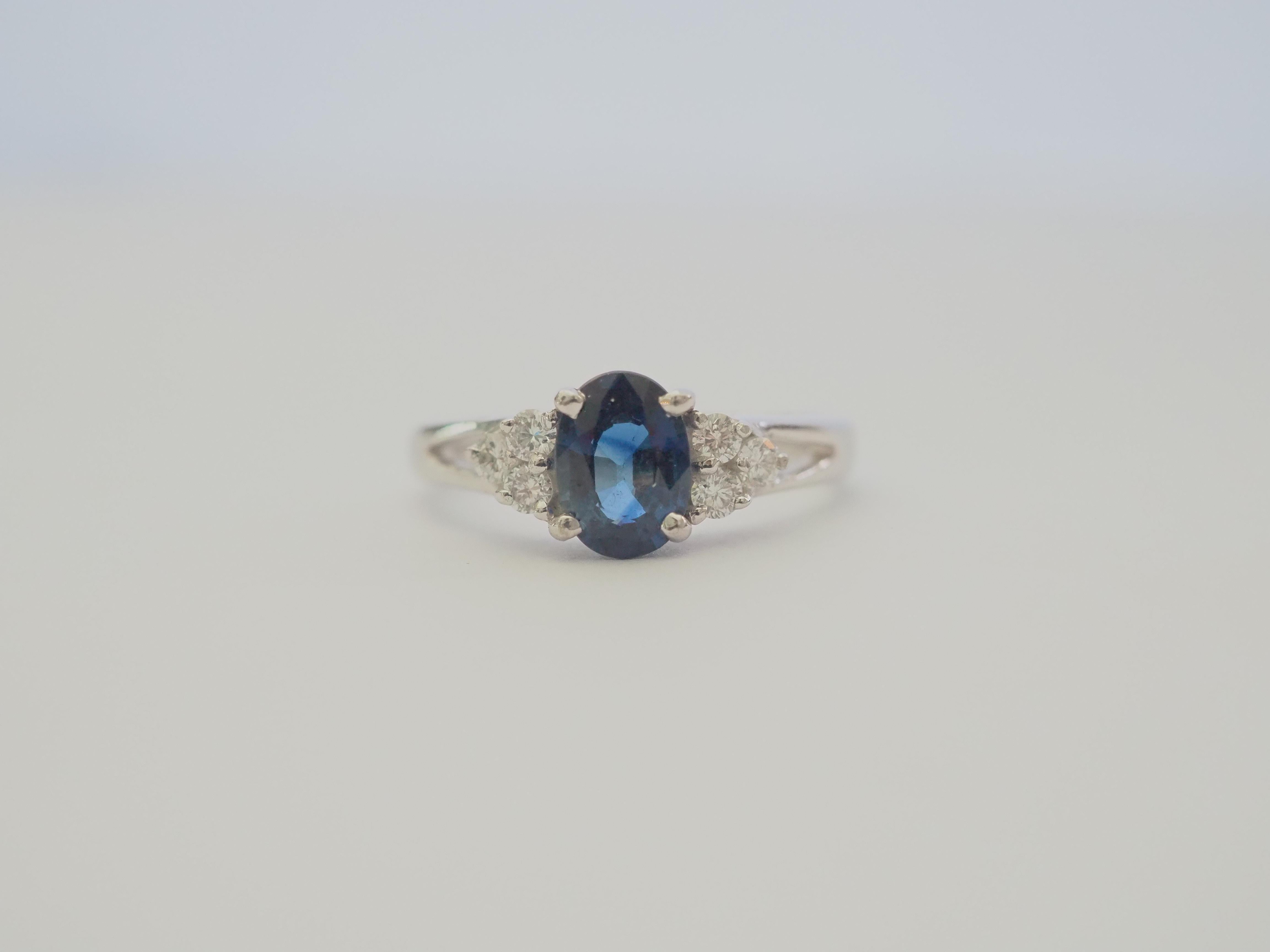 This beautiful engagement ring boasts a very stunning and eye clean blue sapphire with clear and colorless round brilliant cut diamonds! There are 6 round cut diamonds on the accent of the ring, set nicely. The diamonds are of good quality and is