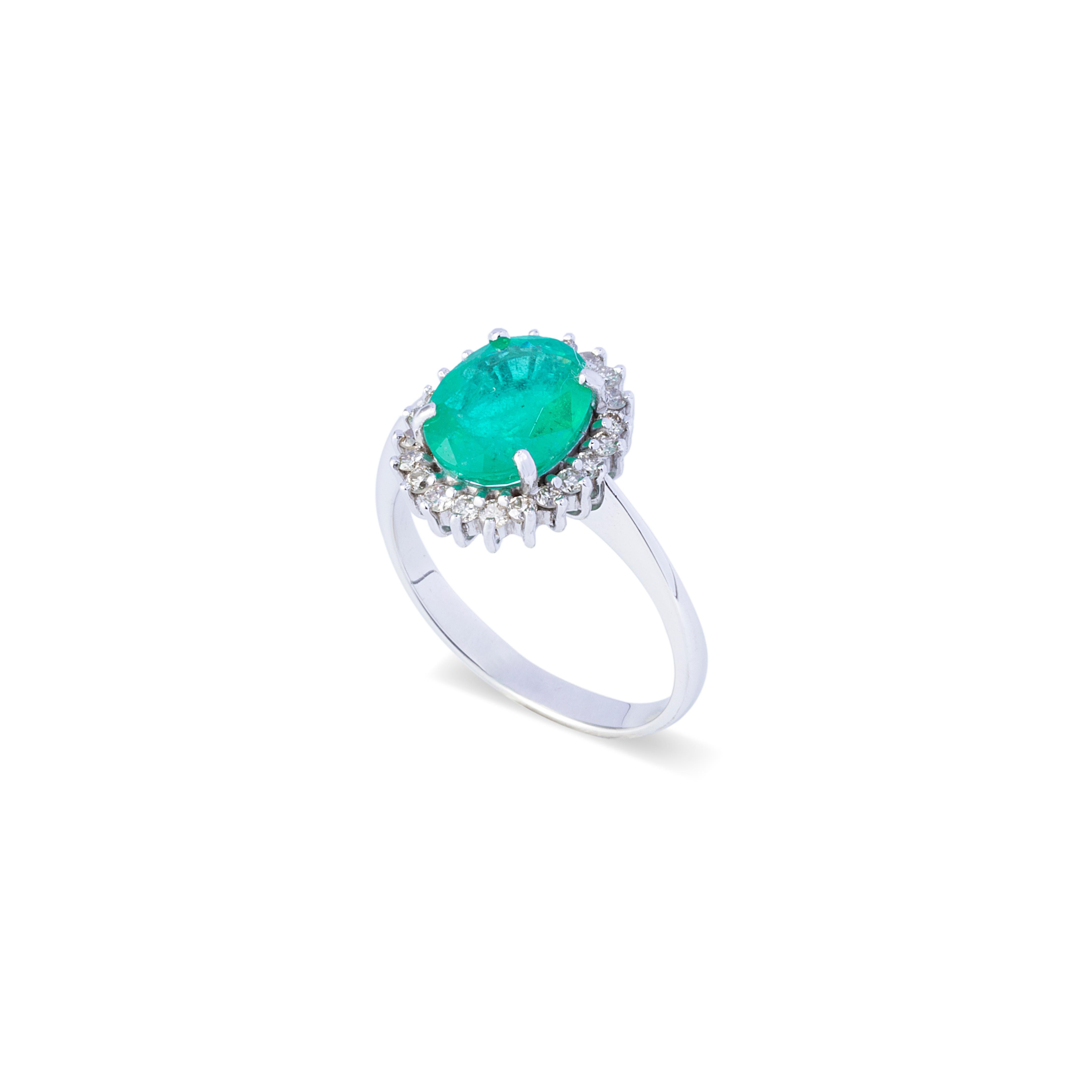 This 18K white gold statement ring is simply gorgeous with the main stone being the 2.36 carats oval emerald with 