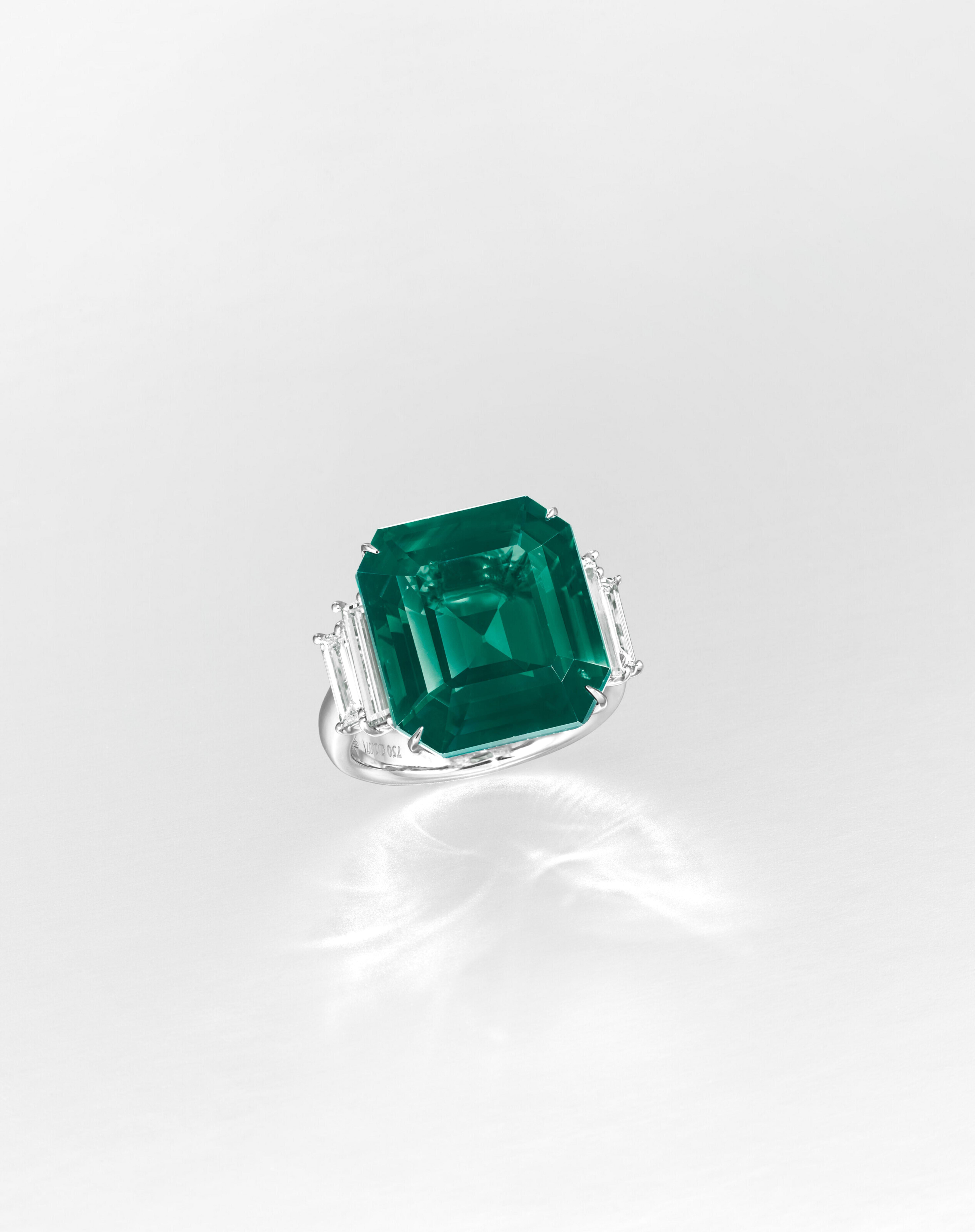 Boldly architectural and radiantly green, this stunning cocktail ring centers around an exceptional 8.46 carat vivid green natural emerald, certified by GRS. Sourced from Zambia and cut in a crisp octagonal step cut, the emerald is richly saturated