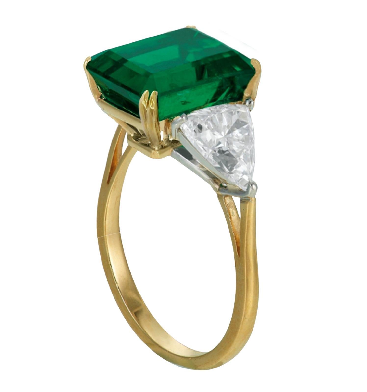 ICA Certified 5.49 Carat Minor Oil Green Emerald Diamond Ring, set in exquisite 18K yellow gold.

This magnificent ring is a celebration of opulence and refinement, featuring a stunning 5.49 carat emerald-cut emerald, certified by ICA. Its
