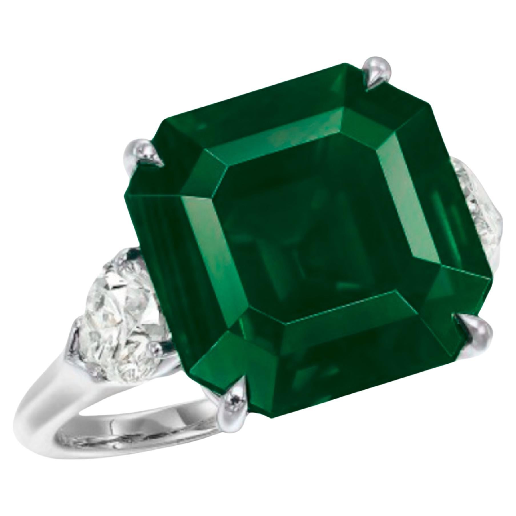Indulge in timeless elegance with this breathtaking ring, featuring a substantial 5.49-carat vivid green emerald, certified by ICA LAB. 

Accompained by a dazzling pair of trillion cut diamonds, this masterpiece is mounted in platinum for a