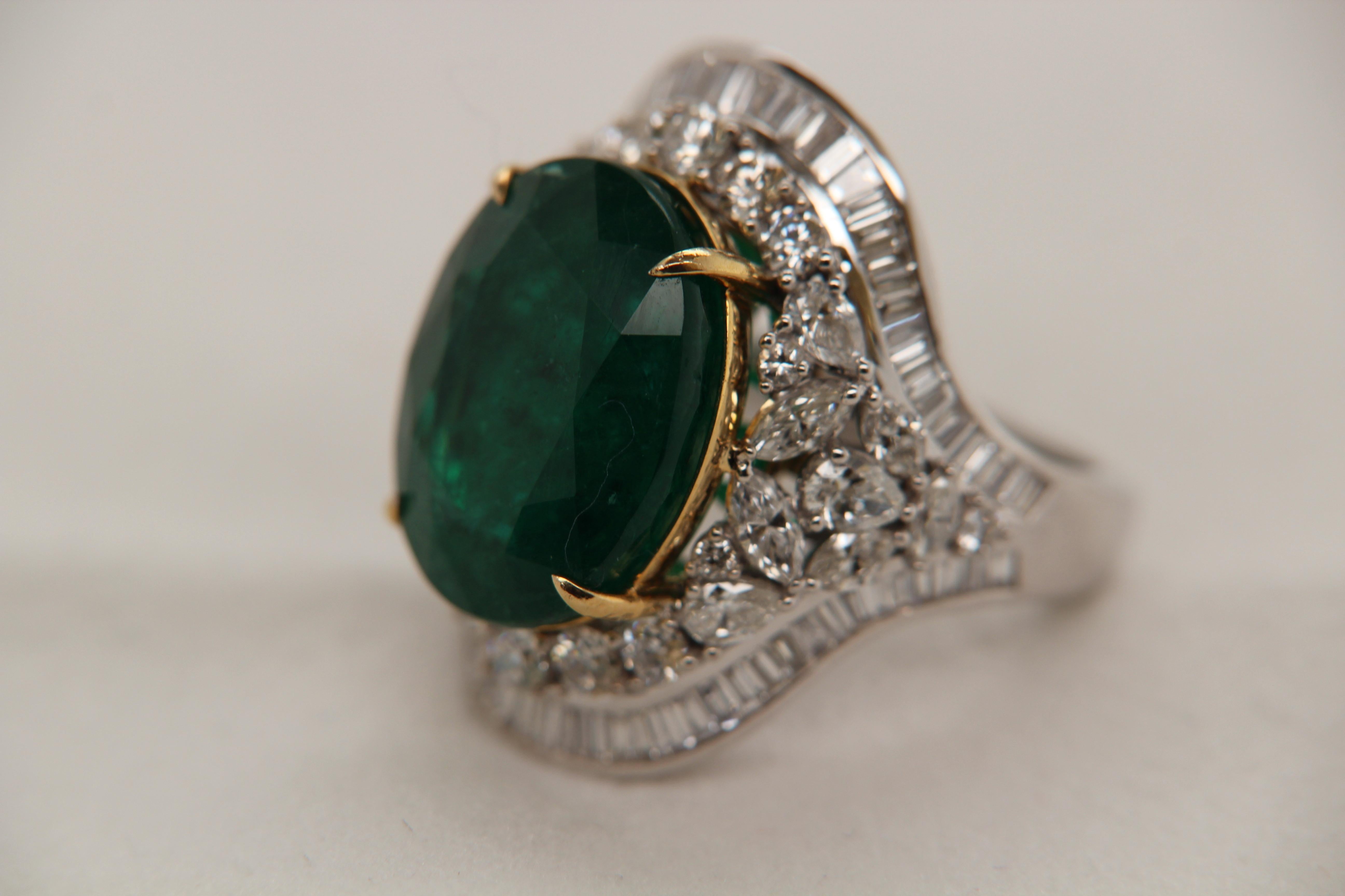 A brand new ICA vivid green 12.91 carat zambian emerald and diamond ring in 18 karat gold. The centre emerald is oval shaped and weighs 12.91 carats. The diamonds weigh 2.93 carats. The gross weight of the whole ring is 13.05 grams.