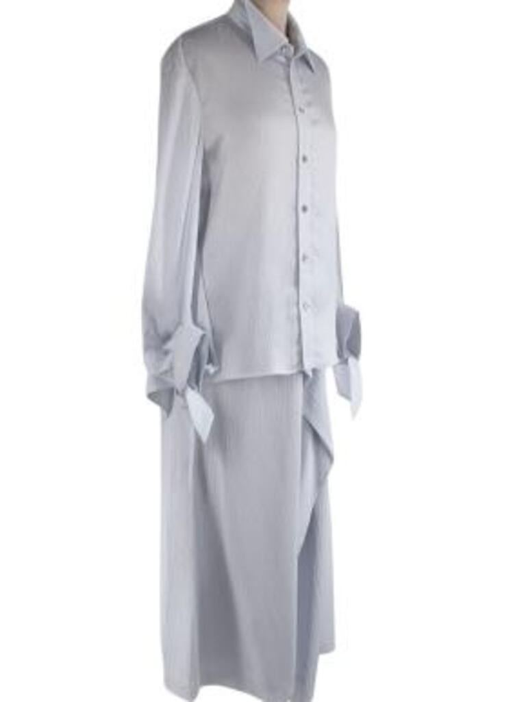 Roland Mouret Ice blue hammered silk blouse & skirt
 
 - Loose fitting, crinkled silk, pointed collar shirt with balloon sleeves and self-tie cuffs
 - Tonal button fastenings down the front opening 
 - Ruffled design and open back 
 - Matching maxi