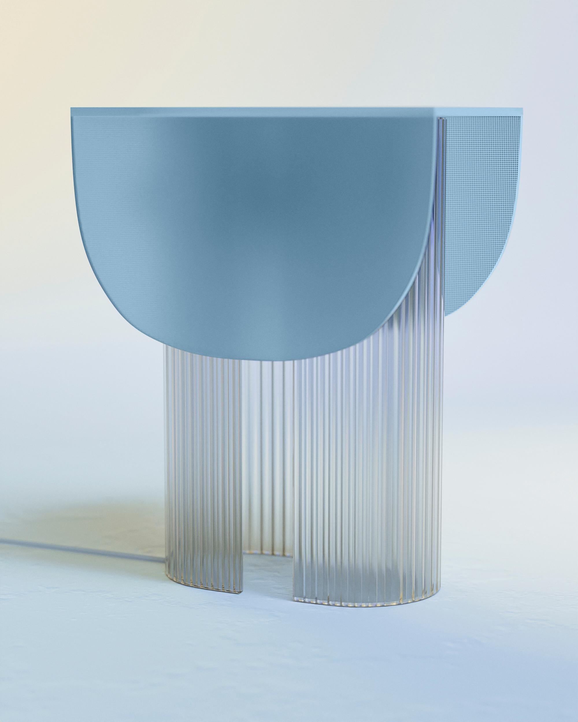 Ice Blue Helia Table Lamp by Glass Variations
Dimensions: W 22 x D 31 x H 40 cm
Materials: Glass.

With this 100% glass table lamp Bina Baitel celebrates light and sun. Its curved patterned glass structure and the satin finished glass cap diffuse a