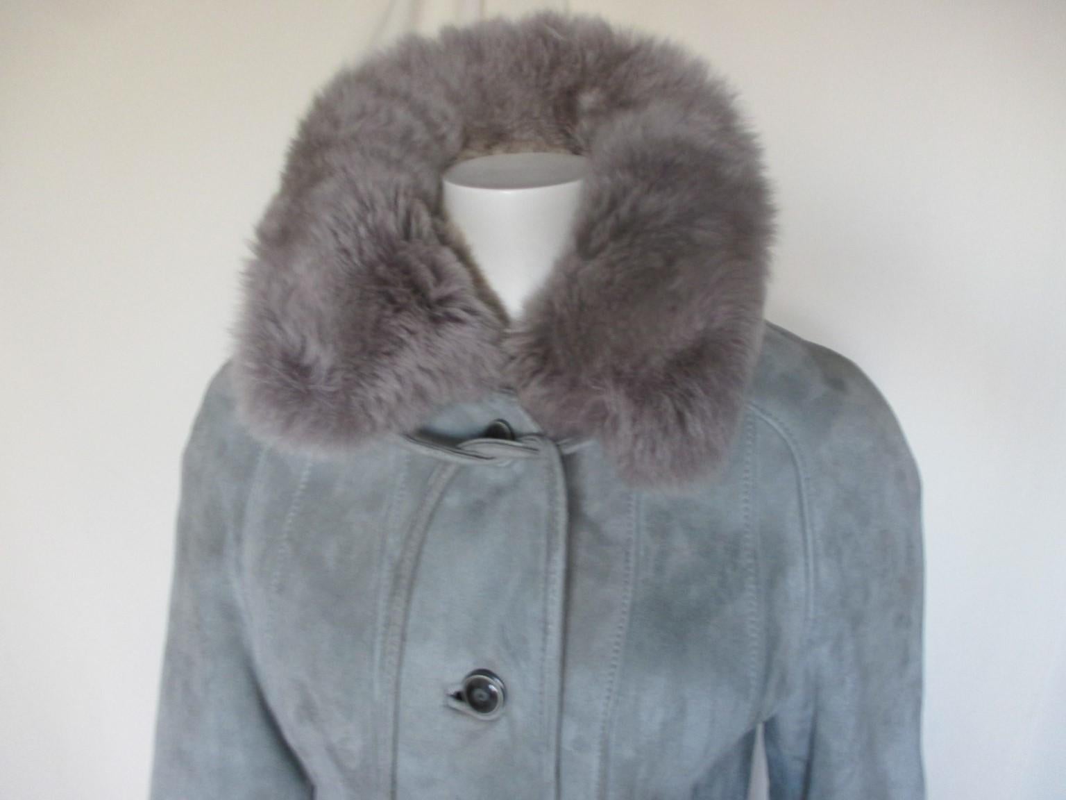 Superb quality suede exterior and lamb interior warm vintage coat.

We offer more lambskin, shearling and fur items, see our frontstore

Details:
With 2 pockets, 5 buttons 
 1 belt at collar and closing belt with fringe.
Color: Ice blue
From 