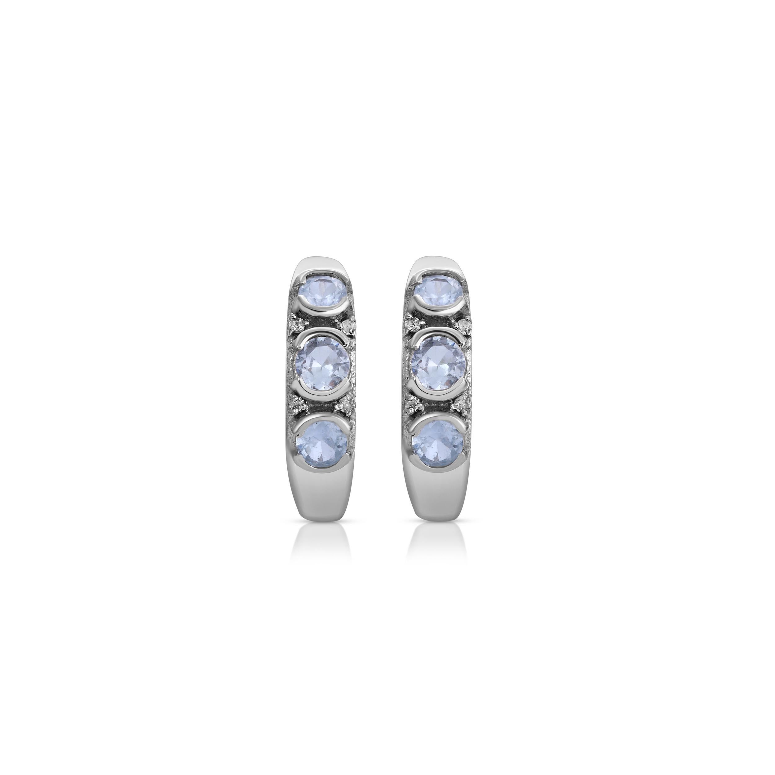 Beautiful hoop earrings in a contemporary design with a glamorous 1980's edge. These earrings feature 2.15 Carats of chunky, triple set ice blue Sapphires enhanced with .02 Carats of Brilliant Cut White Diamonds. These hoops are set in stylish 18