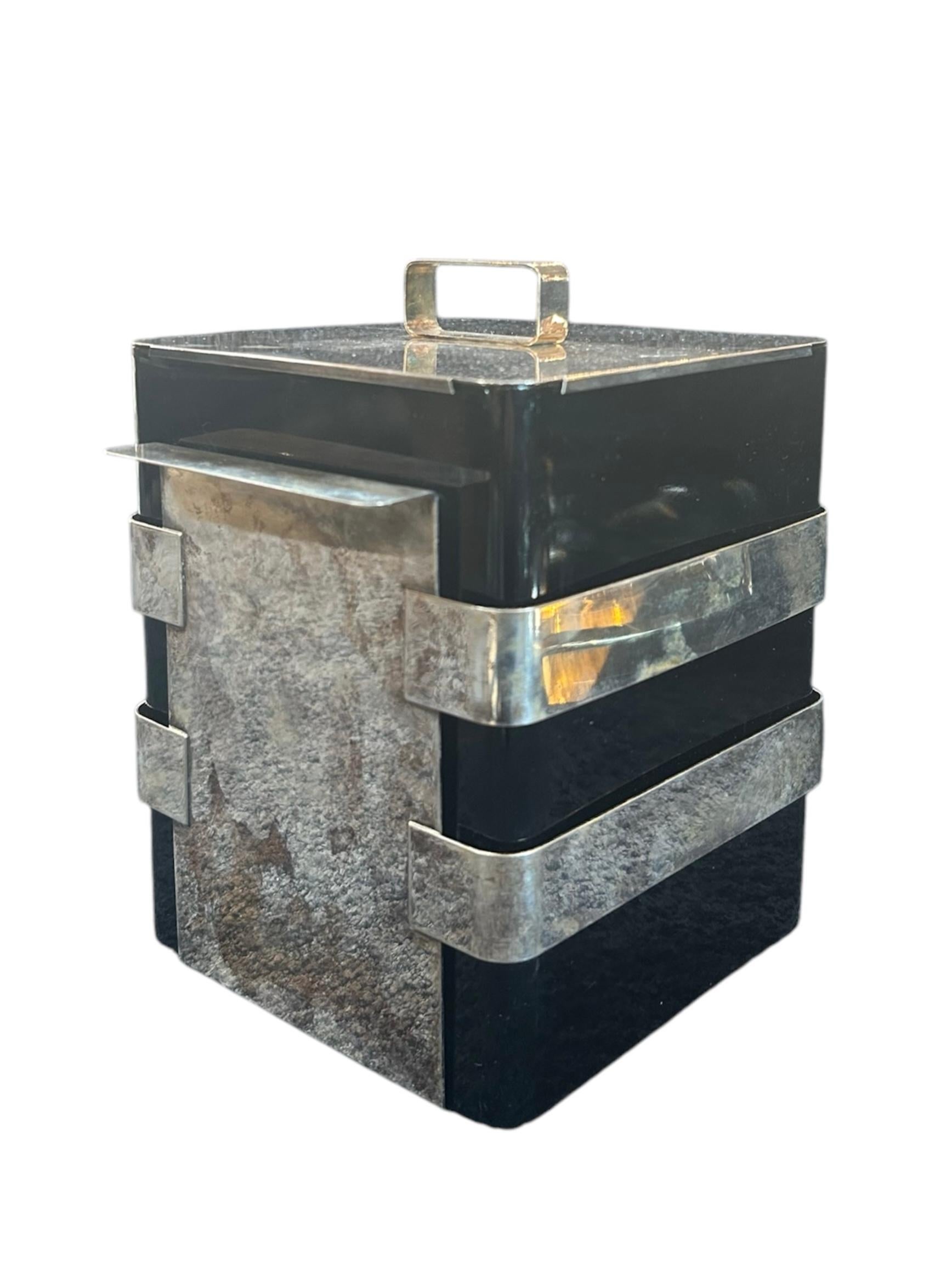 This vintage Italian ice box by Bruno Munari showcases a sleek modernist design with a black body and silver metal accents. Both sculptural and functional, it’s a bold statement piece from 1970s Italian design—perfect for elevating any bar setup.