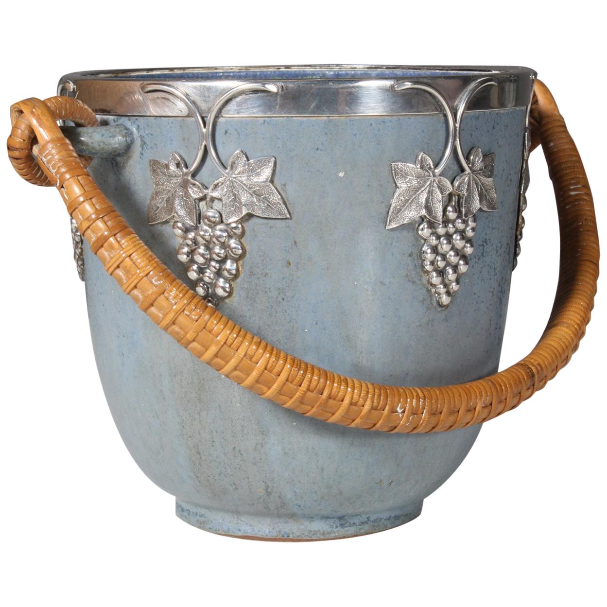 Ice bucket in glazed stoneware of grey blueish-colored shades with paper cord handles. Sterling silver detail. The bucket is designed by Arne Bang, circa 1940-1960.
 
  