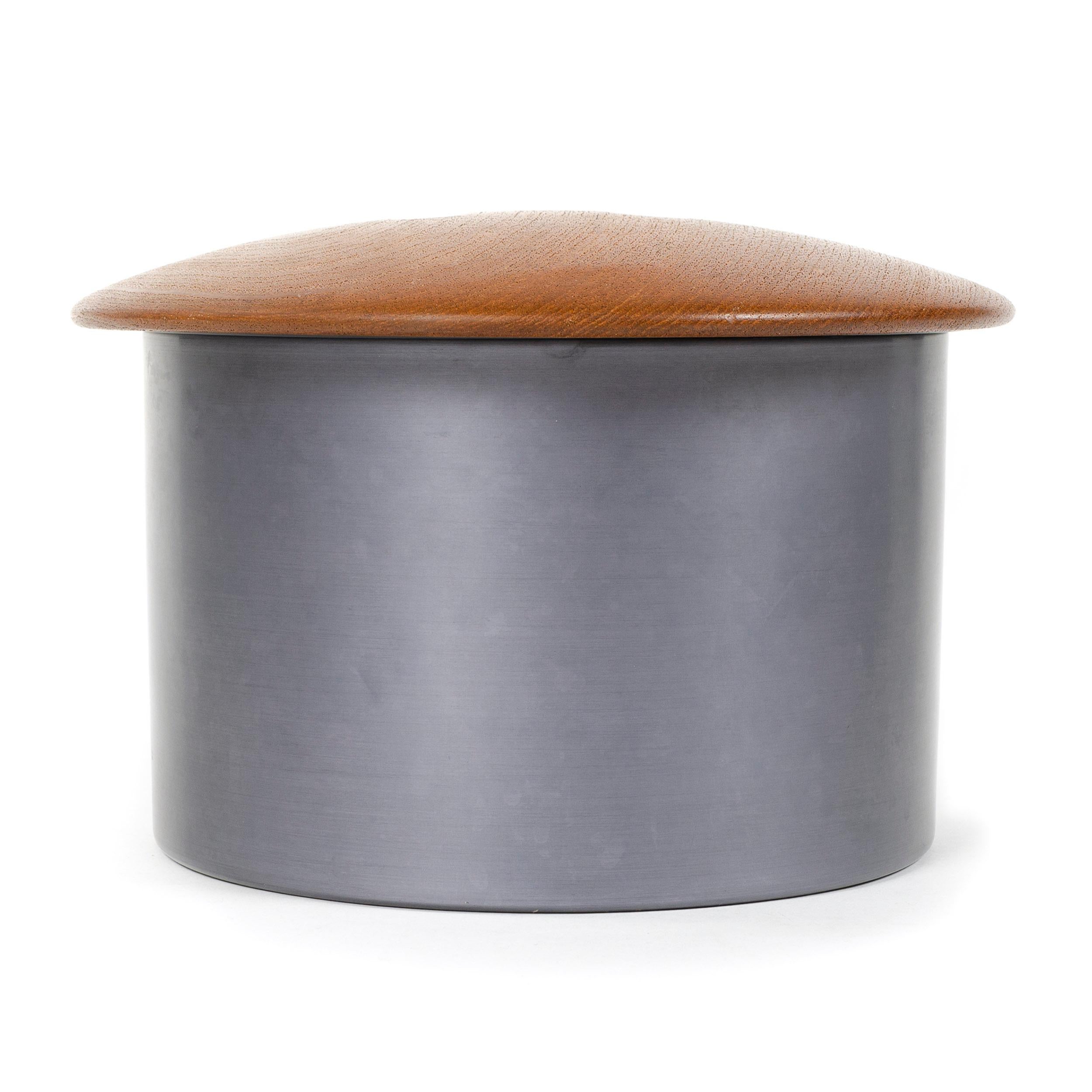 Scandinavian Modern ice bucket by Finn Juhl. Features dark grey anodized aluminum exterior and a wooden lid concealing an insulated black melamine interior. Made in Denmark, circa 1960s.

Finn Juhl was first and foremost famous for his furniture