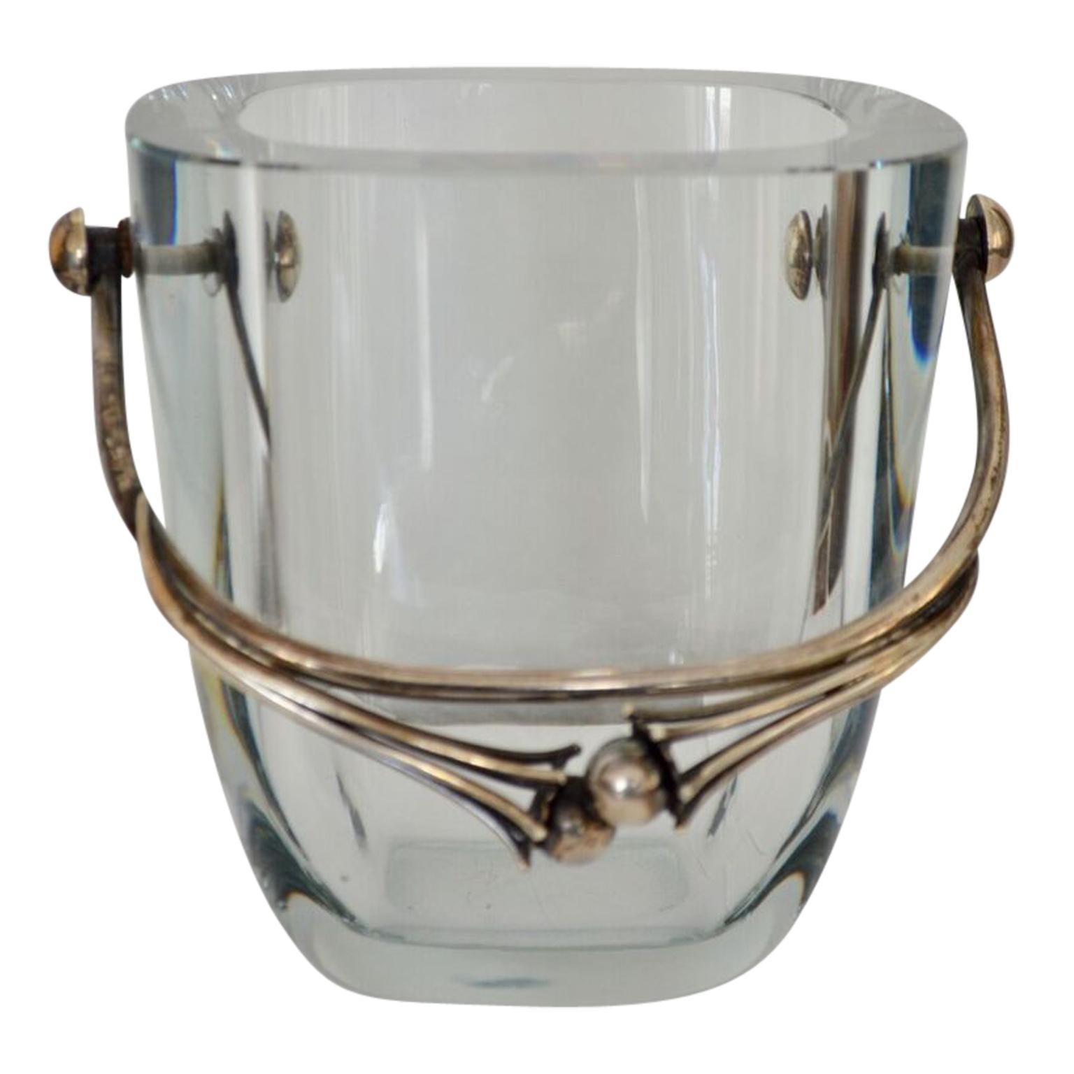 Transparent blue glass vessel, mounted with a finely wrought sterling silver handle with grape decorations. Hallmarked.