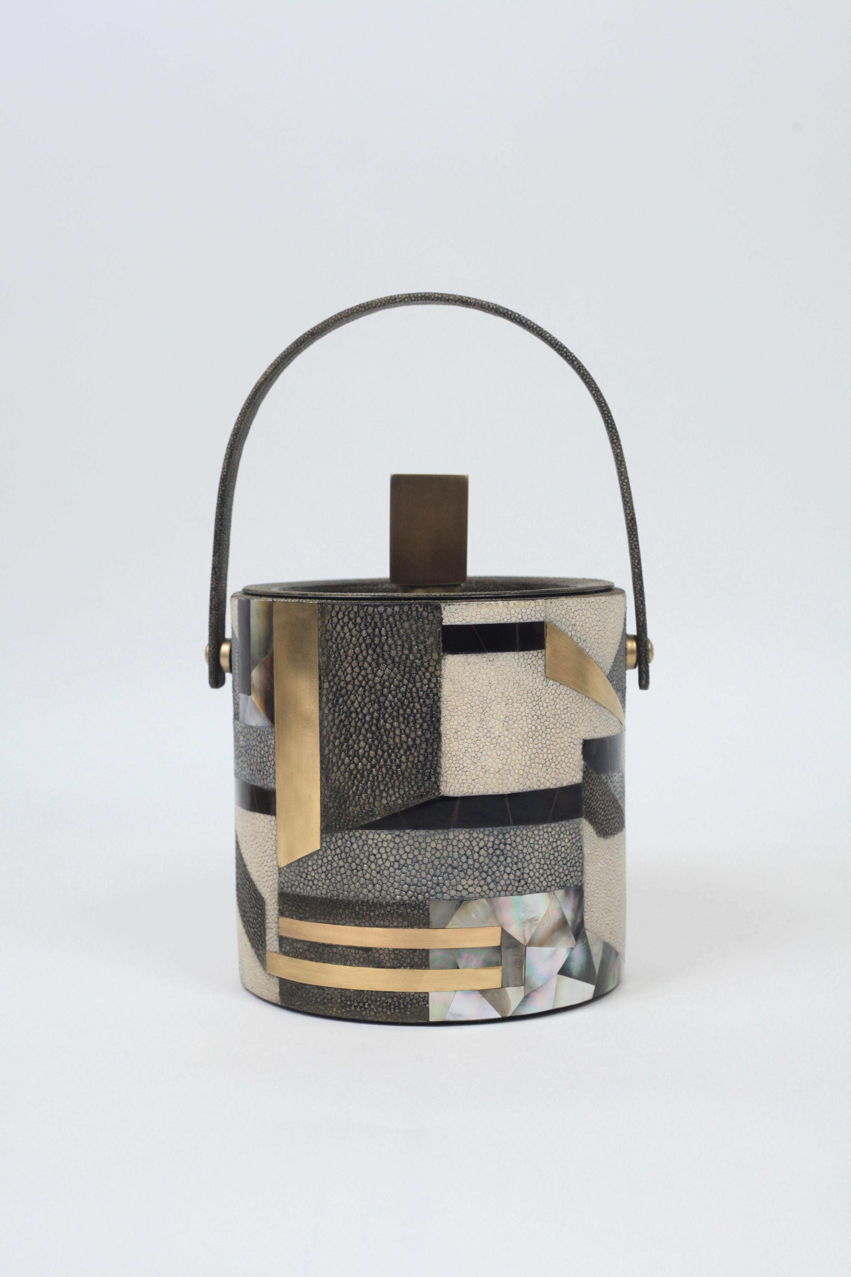 The KIFU PARIS ice bucket is the ultimate luxury bar accessory, inlaid in a mixture of shagreen shell and brass to create a bold geometric pattern. This piece comes with an ice thong. Also available in plain shagreen and plain shell, see images at