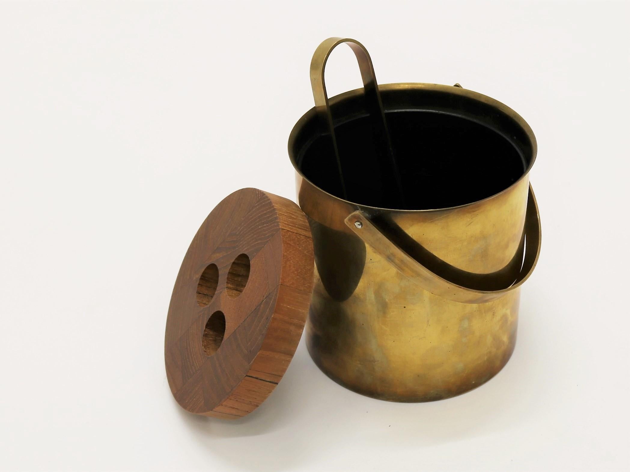 Set of brass ice bucket and tong by Arne Jacobsen for Stelton Brassware. The brassware line was only produced in a very limited amount in the mid 1960s and is today a sought after collectors item that you rarely find.
 