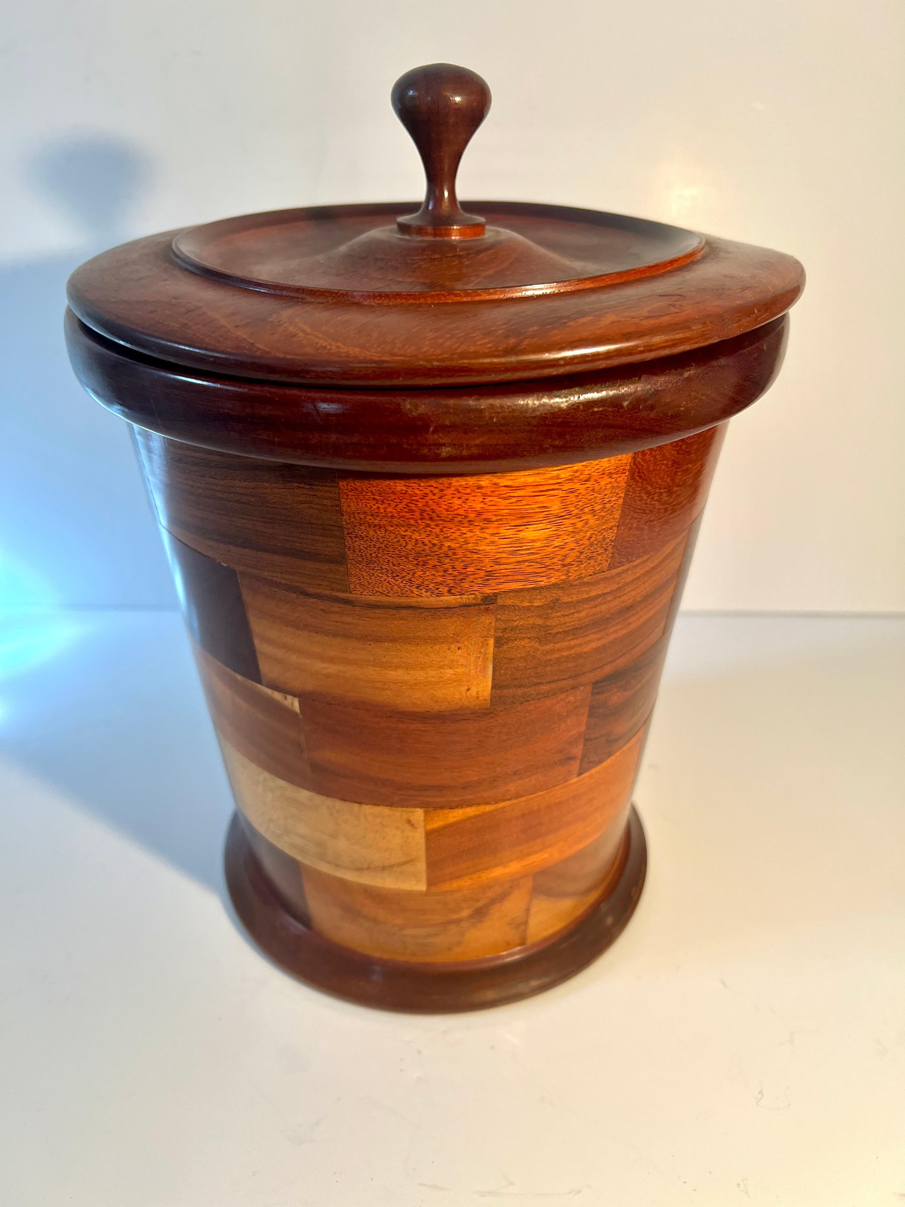 A rare and Beautiful Ice Bucket Made of different Wood Inlay.  Lined with a water proof liner and removable lid.  The bucket is a complement to many styles of bars or in a kitchen with with a Ralph Lauren or Natural theme.

The style is graceful and