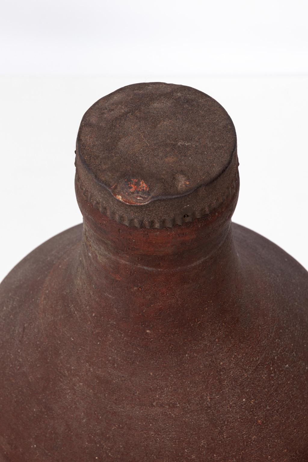 Large fiber composition Moxie store display bottle with metal cap, circa 1900s-1920s. Displayed in a general store to advertise Moxie Nerve Drink. Made in the United States. Please note of minor chips on the base and discoloration due to wear with