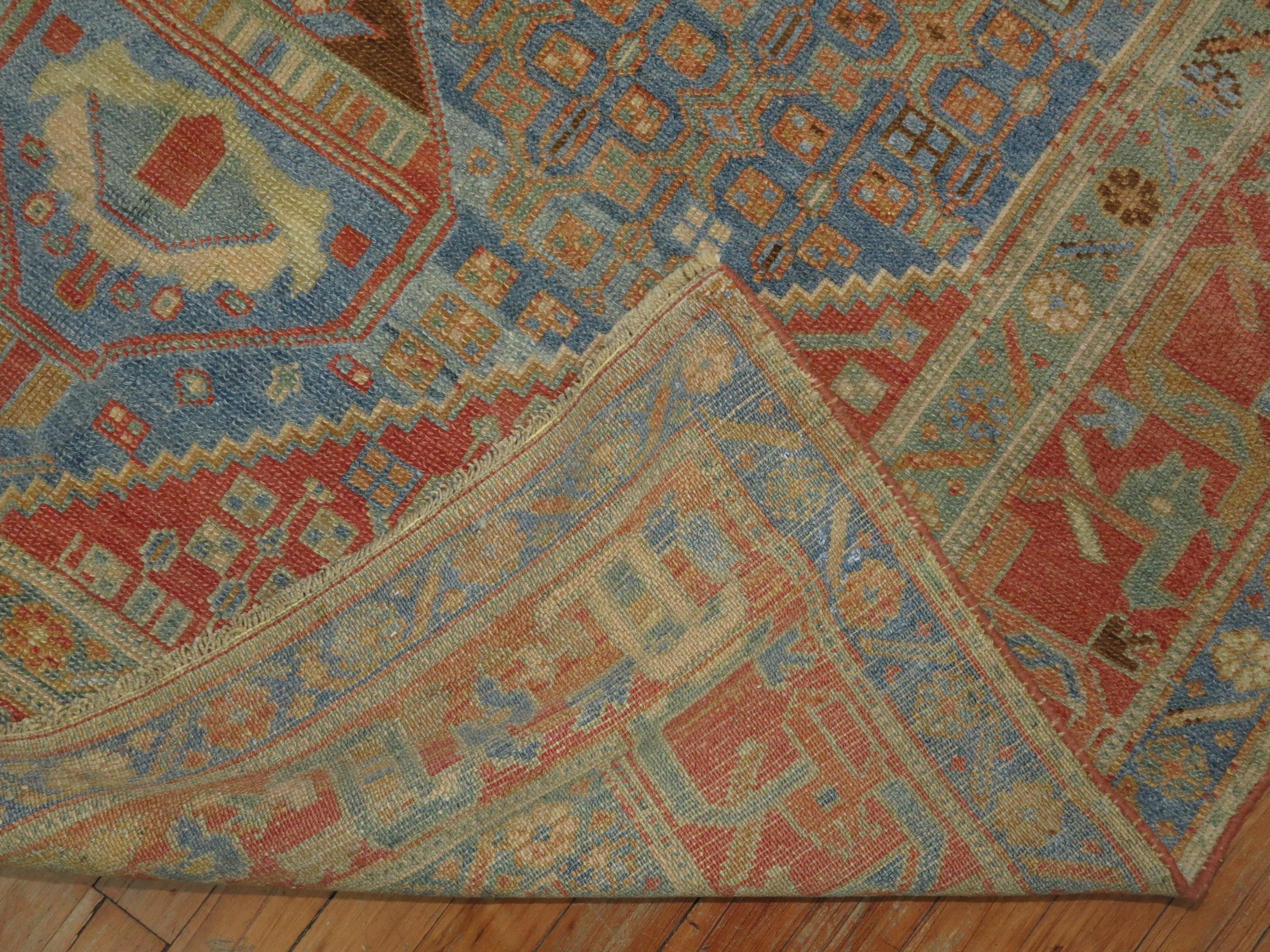 Highly decorative antique early 20th century Persian Malayer rug. Predominant shades in blue and terracotta.
  
 