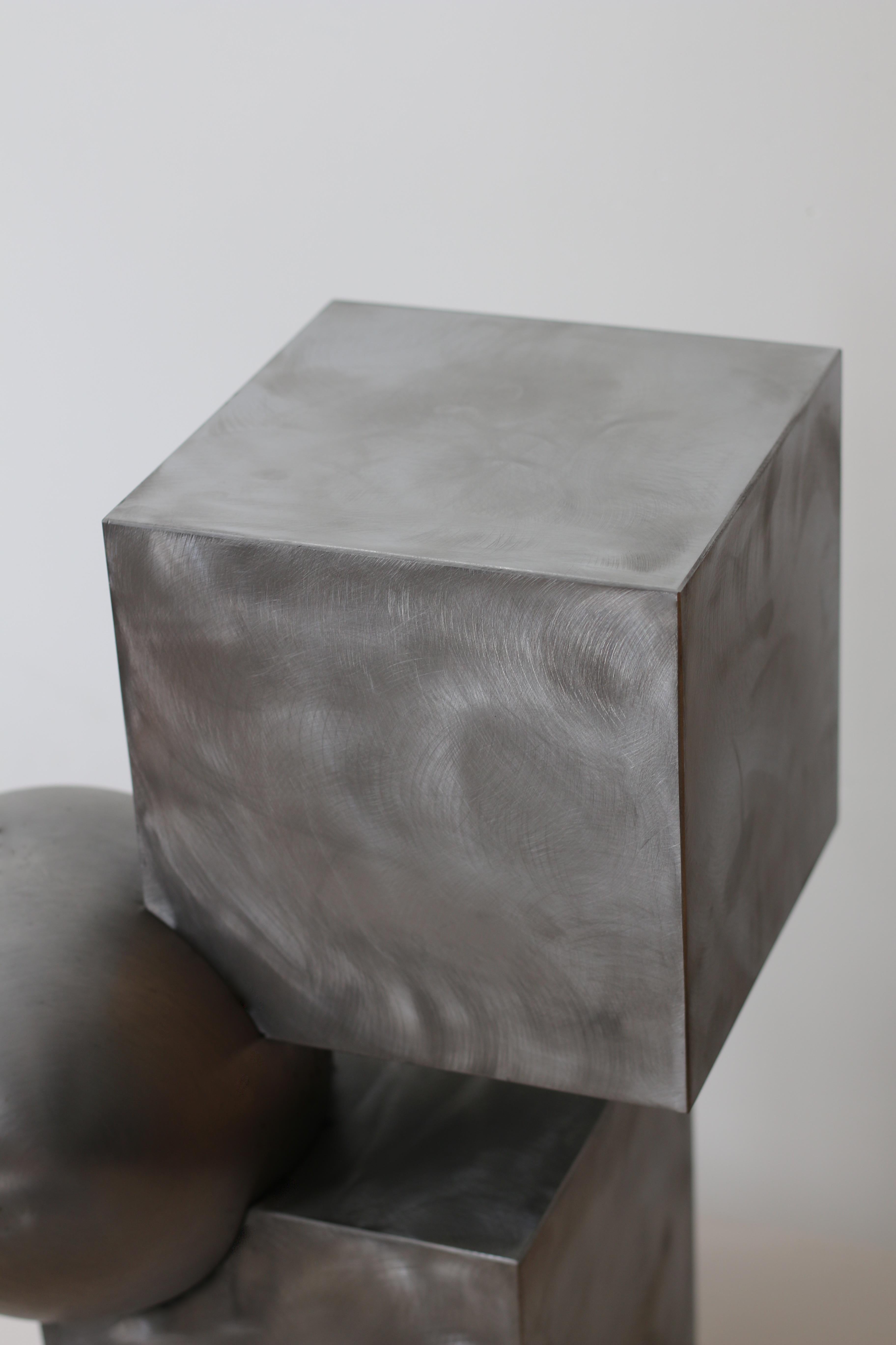 This is the newest version of best-selling 'Ice Cube' sculptural side table in brushed steel by Studio Experimental head designer Sabine Mezkaze Berzina.
It features clean geometry and Brutalist influenced design. Heavy weight and durable.