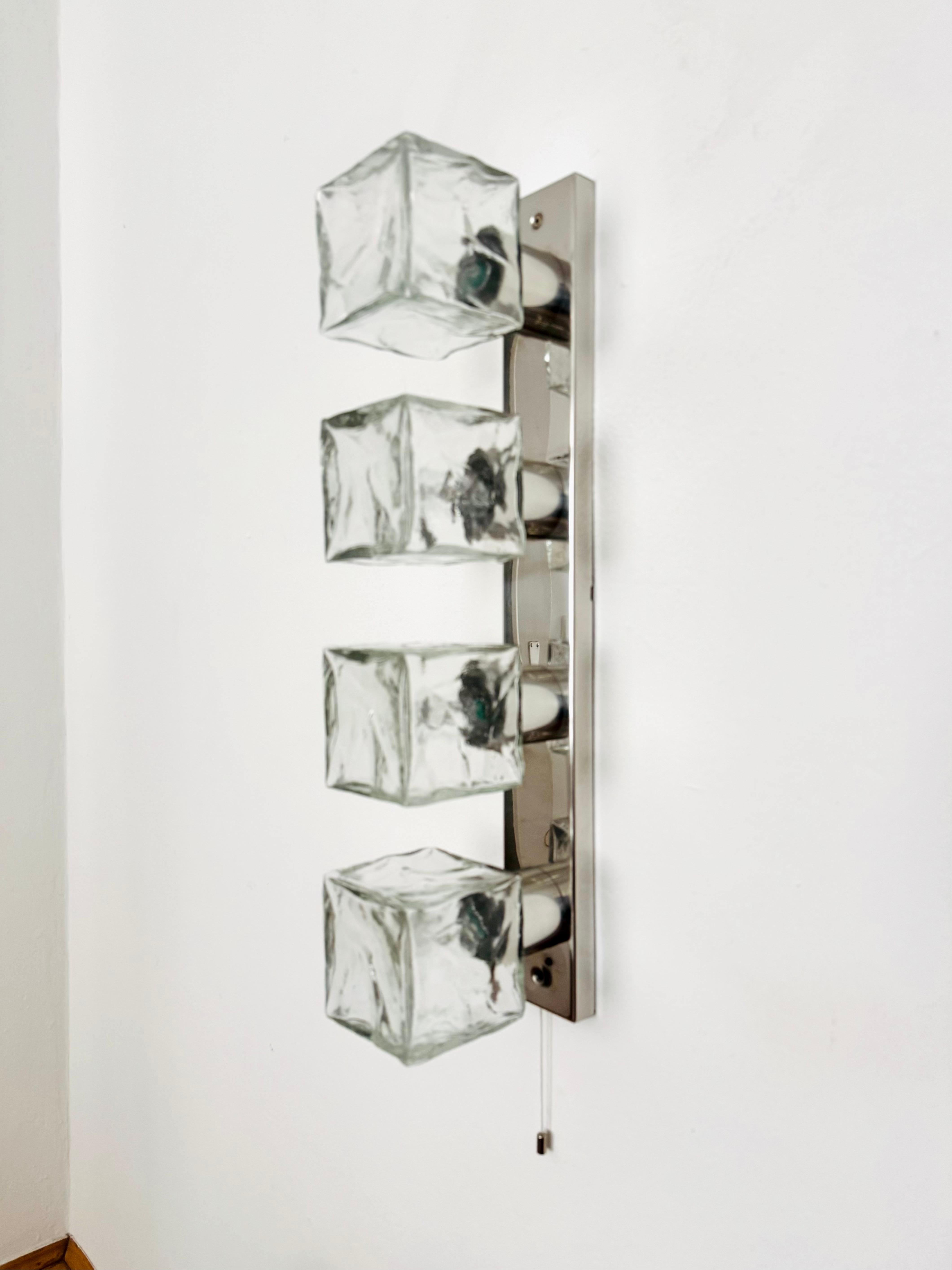 Wonderful ice glass wall lamp or ceiling lamp from the 1960s.
The very beautifully shaped Murano glass elements spread an impressive sparkling light game.
Very high quality workmanship and a real eye -catcher for every home.

Design: J.T.