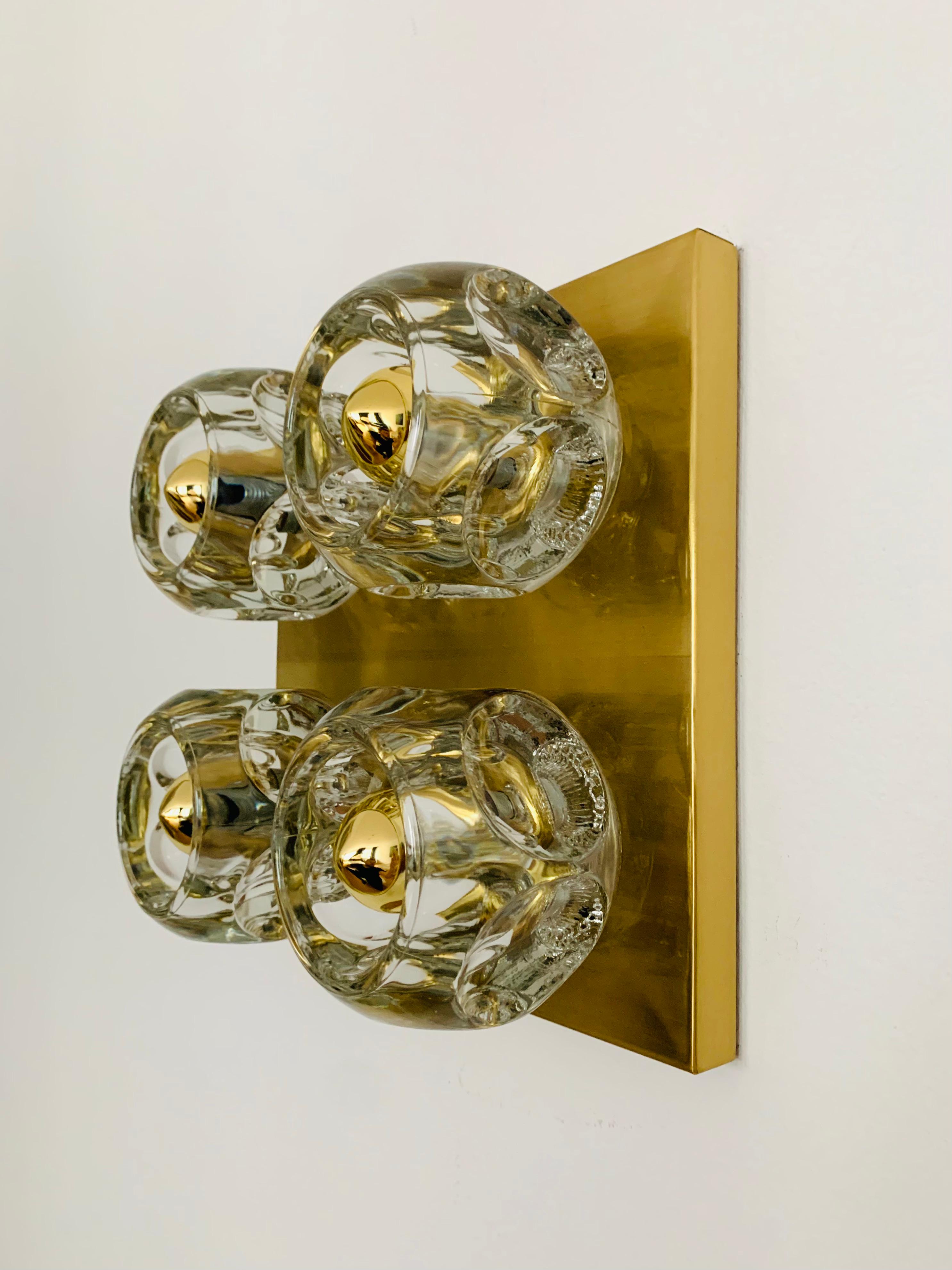 Fantastic ice cube wall lamp or ceiling lamp by Peill and Putzler from the 1960s.
Very nice design and shape which spreads a great play of light in the room.

Condition:

Very good vintage condition with slight signs of wear consistent with