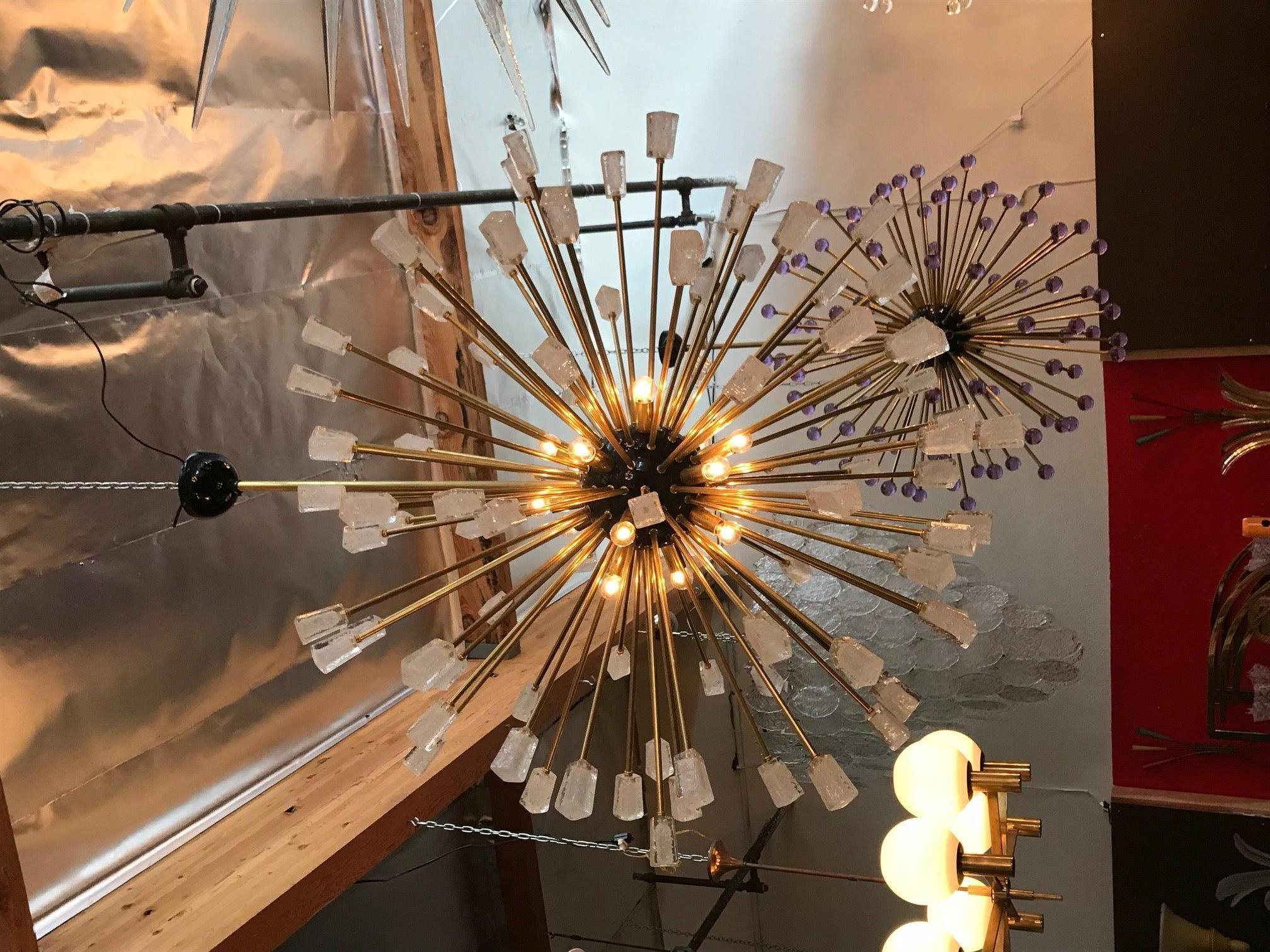 Modern Italian Sputnik chandelier composed of 96 unique clear Murano glass cubes blown in Pulegoso technique to provide an opaqued appearance with clustered bubbles within the glass, mounted on brass metal frame with black enameled center and canopy