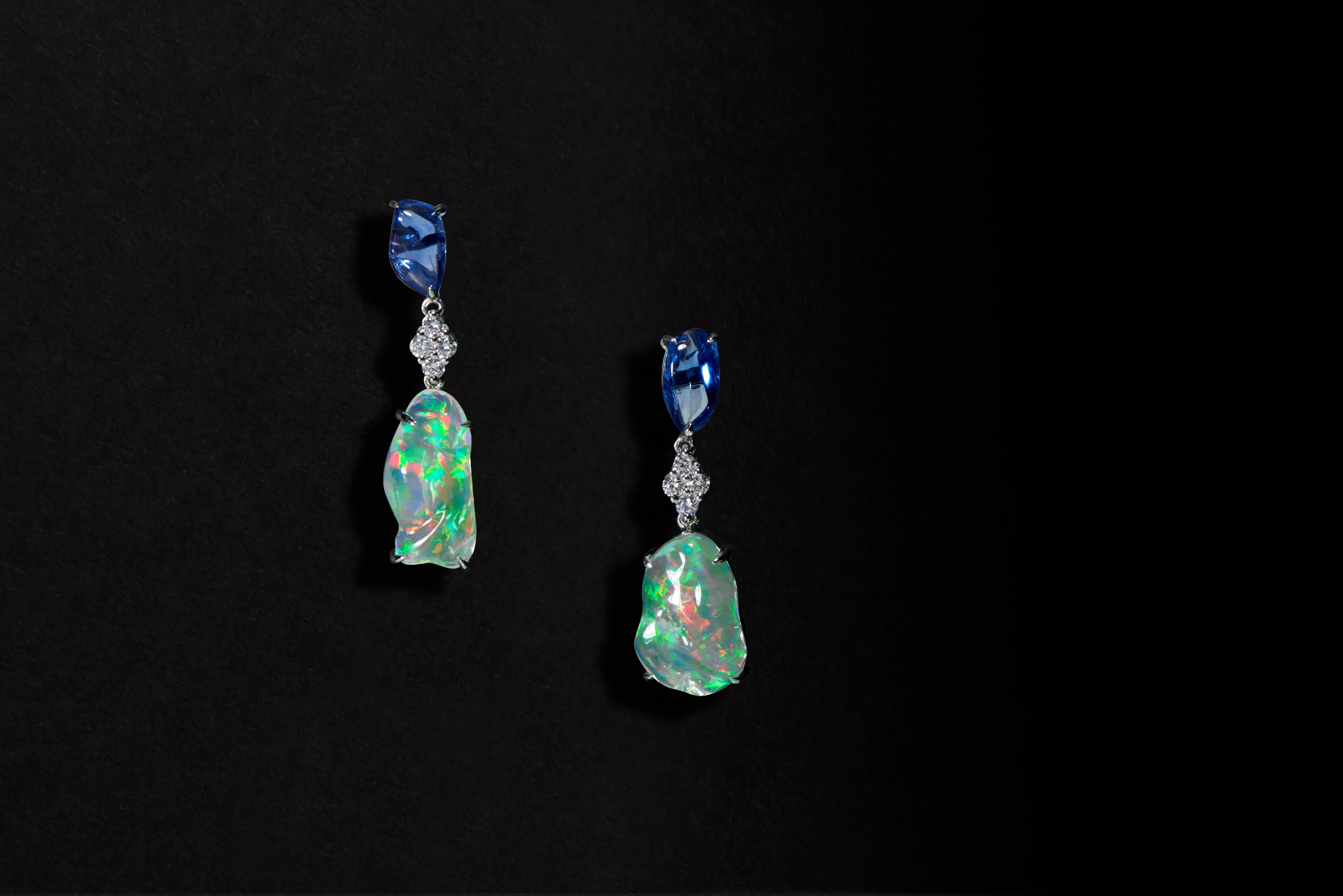 A dramatic combination of gemstones and a dazzling array of vivid hues create a unique and statement-making impression with Ri Noor’s Ice Drops Blue Sapphire Clear Fire Opal and Diamond Earrings. A saturated blue sapphire, in a bold organic natural