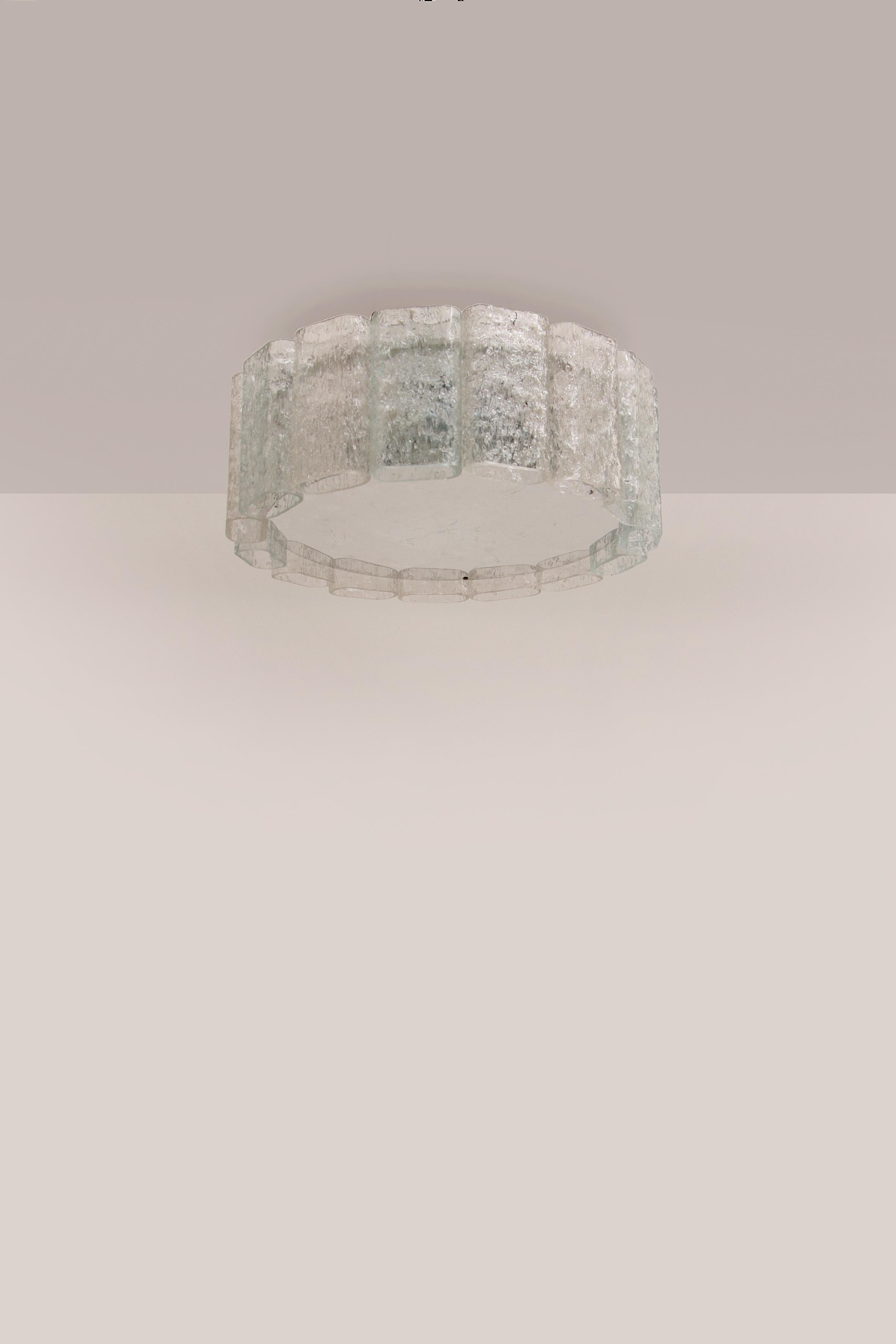 This is a very beautiful ice glass hanging lamp ceiling lamp.

This beautiful lamp was produced in the 1960s by Doria Leuchten.

The lamp consists of 18 mouth-blown large glass cylinders that are made of crystal clear relief glass. The glass