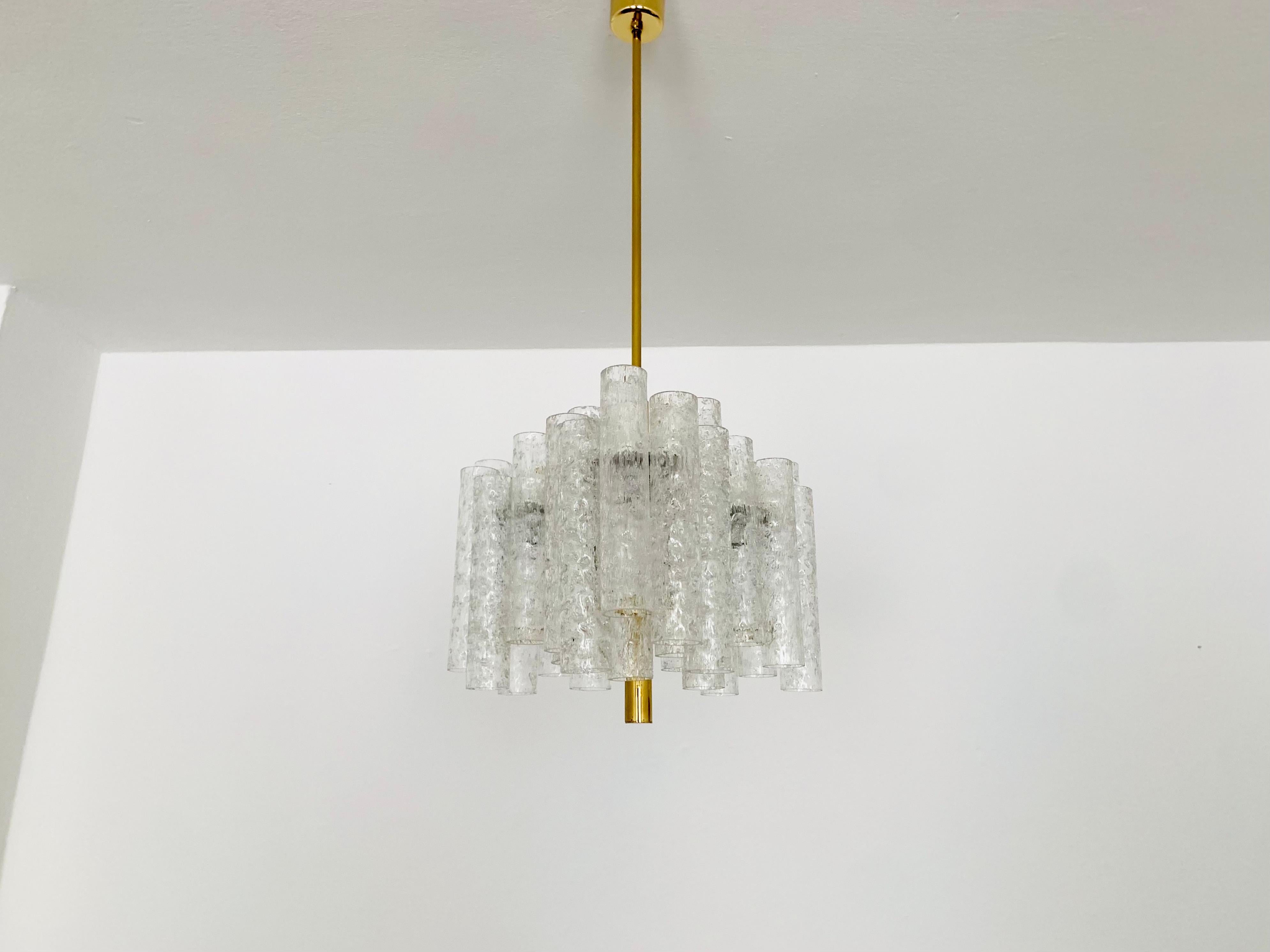Fabulous ice glass chandelier from the 1960s.
The lamp with the 27 glasses is very noble and rare.
The structure in the glasses creates a spectacular play of light.
An absolute eye-catcher.

Manufacturer: Doria

Condition:

Very good vintage