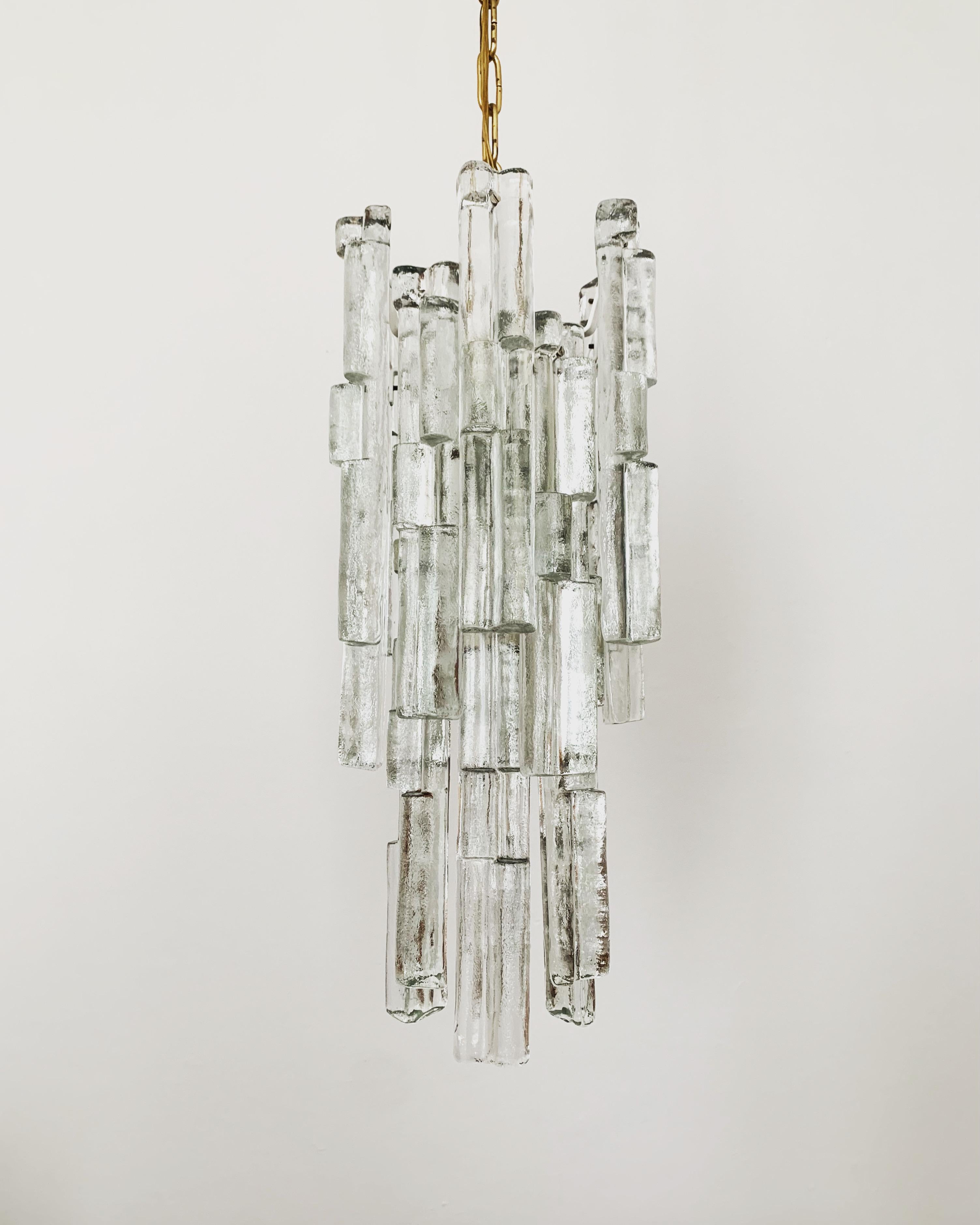 Ice glass lamp by J.T. Kalmar from the 1960s.
The 18 glass elements spread a very noble light.
Very high-quality workmanship and a real eye-catcher for every home.

Design: J.T. Kalmar
Manufacturer: Franken KG

Condition:

Very good vintage