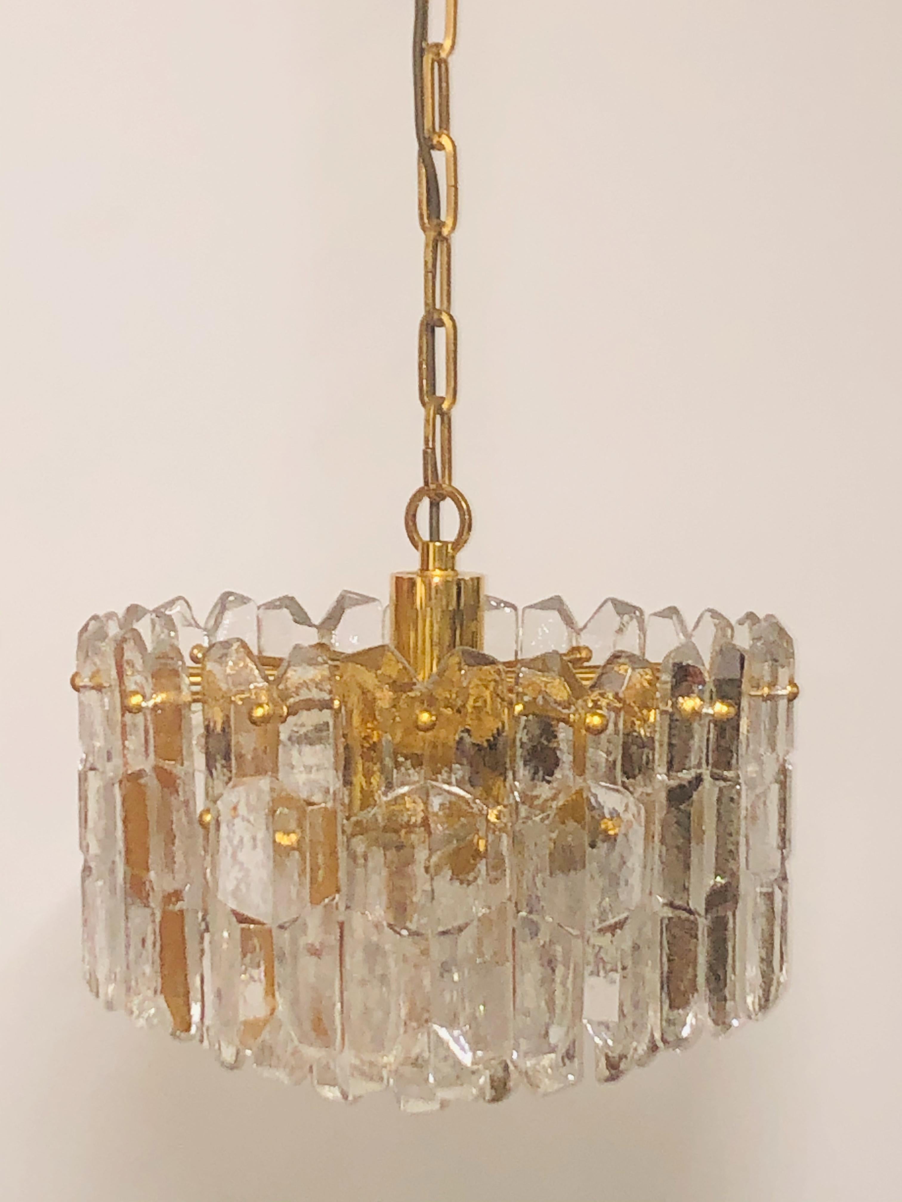 A midcentury chandelier by J.T.Kalmar, Austria, Vienna, circa 1960s.
Seven-light gilt brass frame suspended with thick glass elements.
Socket: 7 x e14 (Edison) base for standard screw bulbs.

   