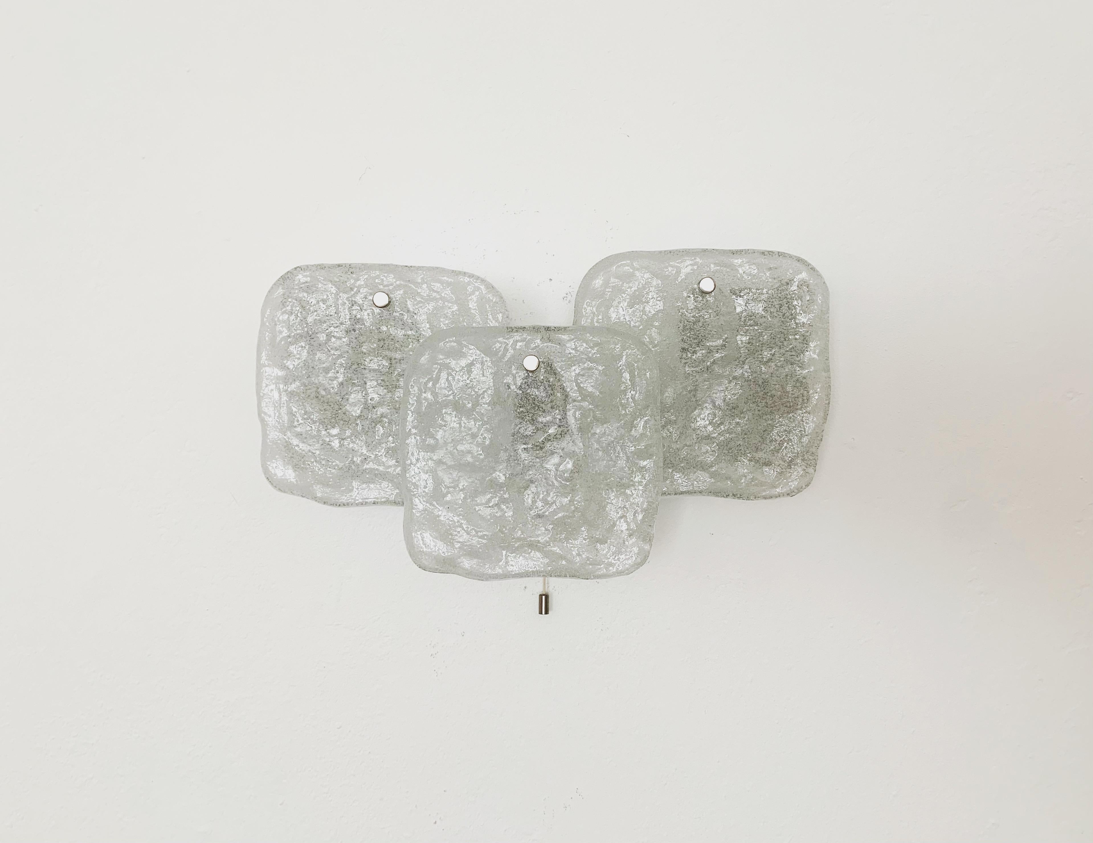 Stunning Murano glass wall lamp from the 1960s.
The 3 heavy ice glass elements spread an elegant light.
High quality.

Condition:

Very good vintage condition with slight signs of wear consistent with age.
The metal parts are